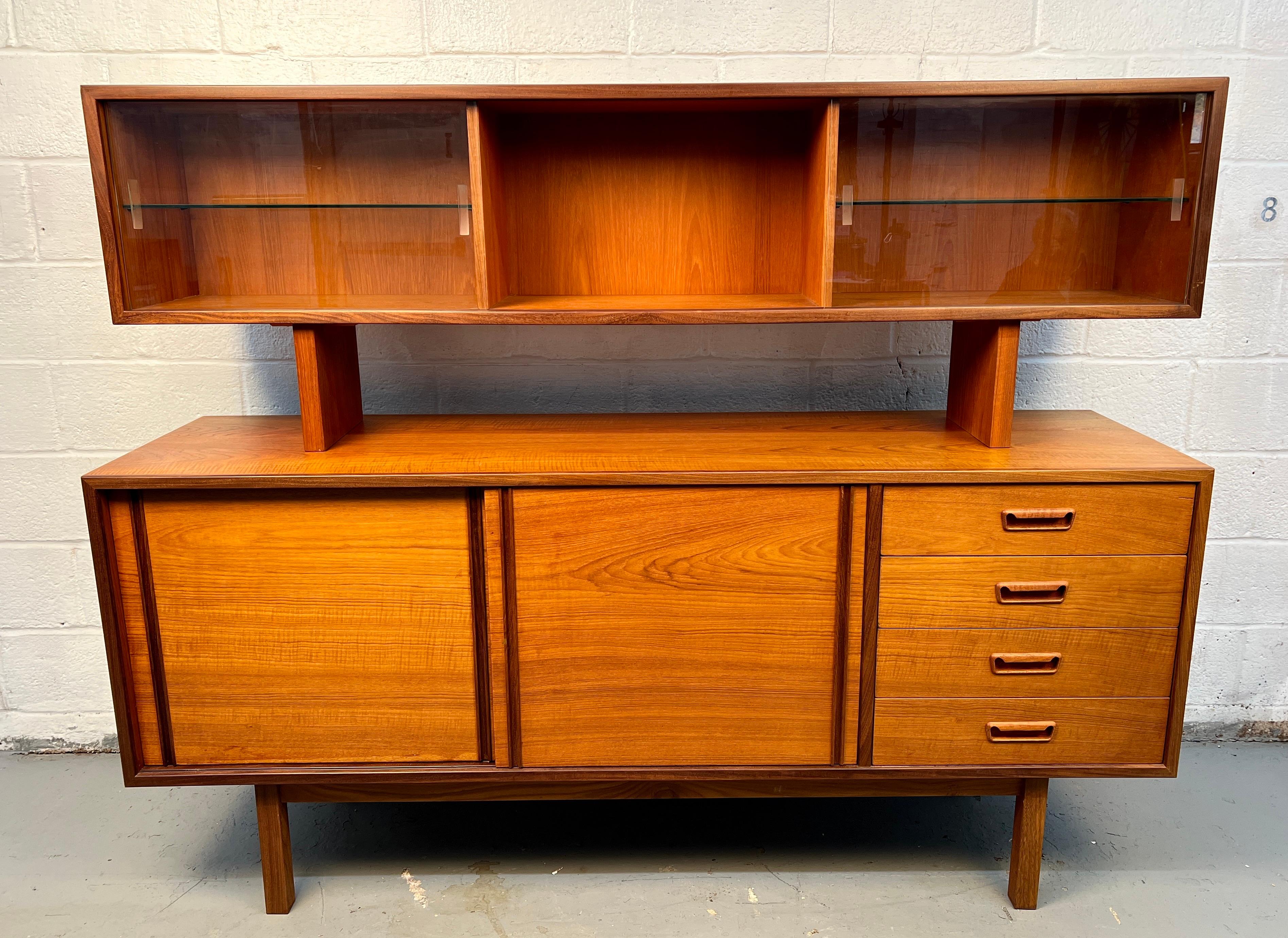 Elegante credenza in teak della metà del secolo scorso di R.S. Associates di Montreal, dotata di un piano d'appoggio rimovibile con ante in vetro e ripiani in vetro regolabili, perfetta per essere utilizzata come libreria o vetrina. La credenza