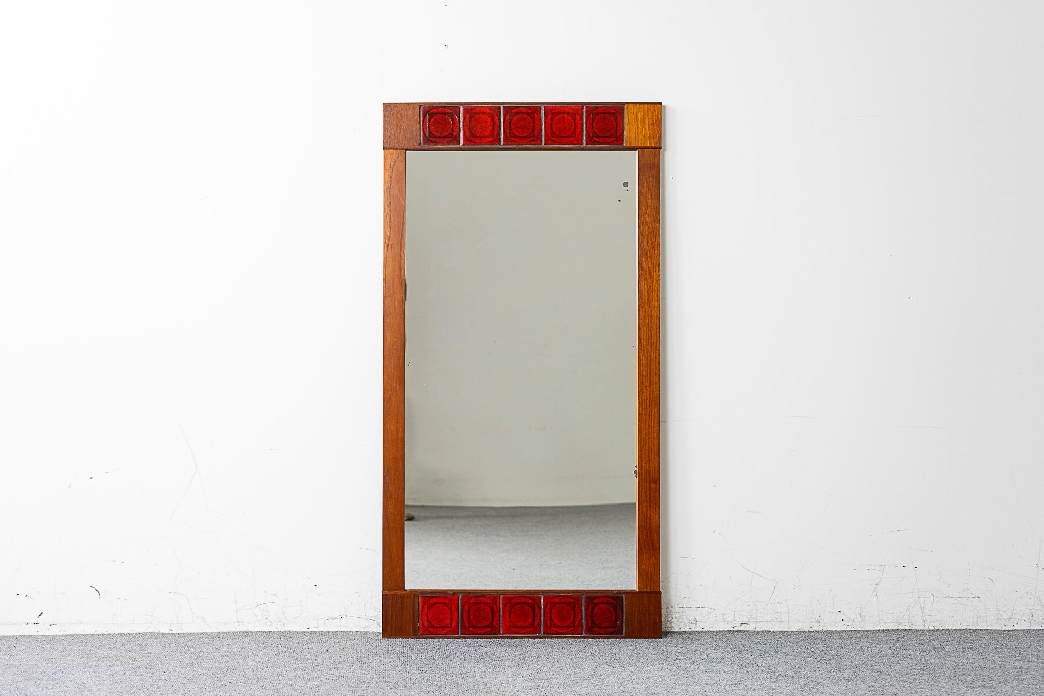 Teak and tile Danish mirror, circa 1960's. Bordered by beautiful ceramic tiles with  geometric relief. Teak frame has stunning grain, original glass has small minor marks from oxidation.

Please inquire for international and remote shipping rates.