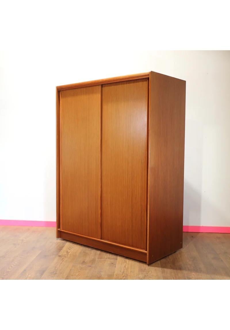 A stunning triple Mid Century armoire by Autinsuite. This is a great looking classic with plenty of storage and beautiful sliding doors is functional and stylish at the same time