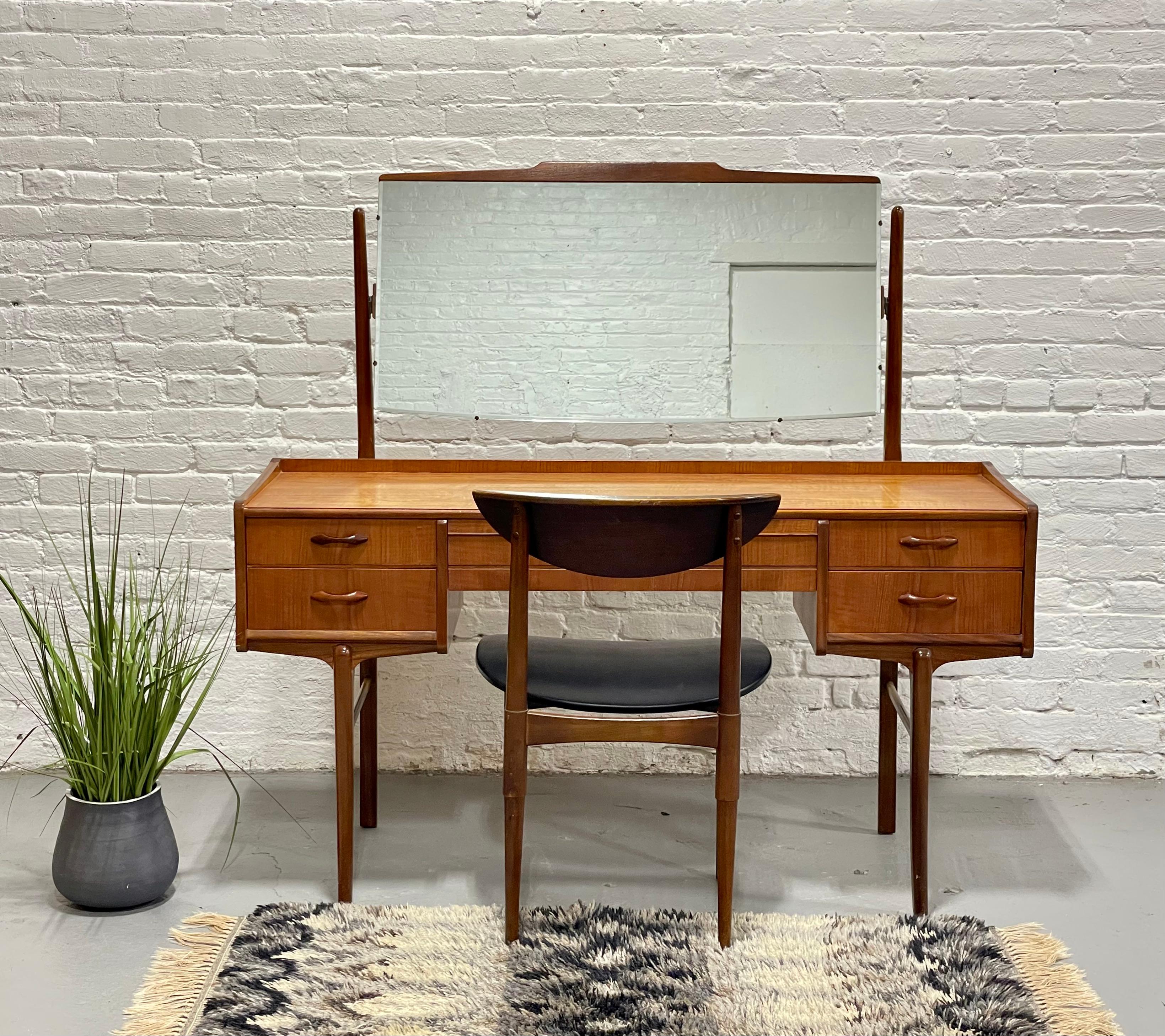 Mid Century Modern Teak Vanity / Desk + Large Mirror, c. 1960’s.  This incredibly unique piece is the perfect multi-functional piece - use it as an office workspace or a convenient table to lay out all your makeup with a large tilting mirror at the