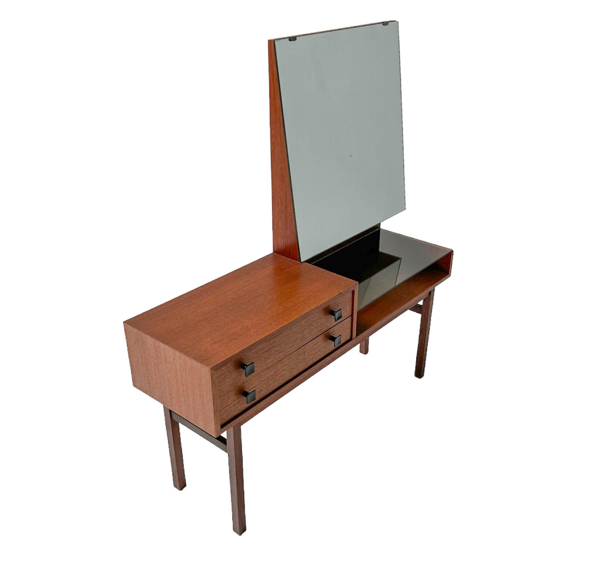 Stunning and elegant Mid-Century Modern vanity or dressing table.
Striking Dutch design from the 1970s.
Solid teak and original teak veneer base with original black lacquered knobs on the two drawers.
Original mirror and glass shelf on the right