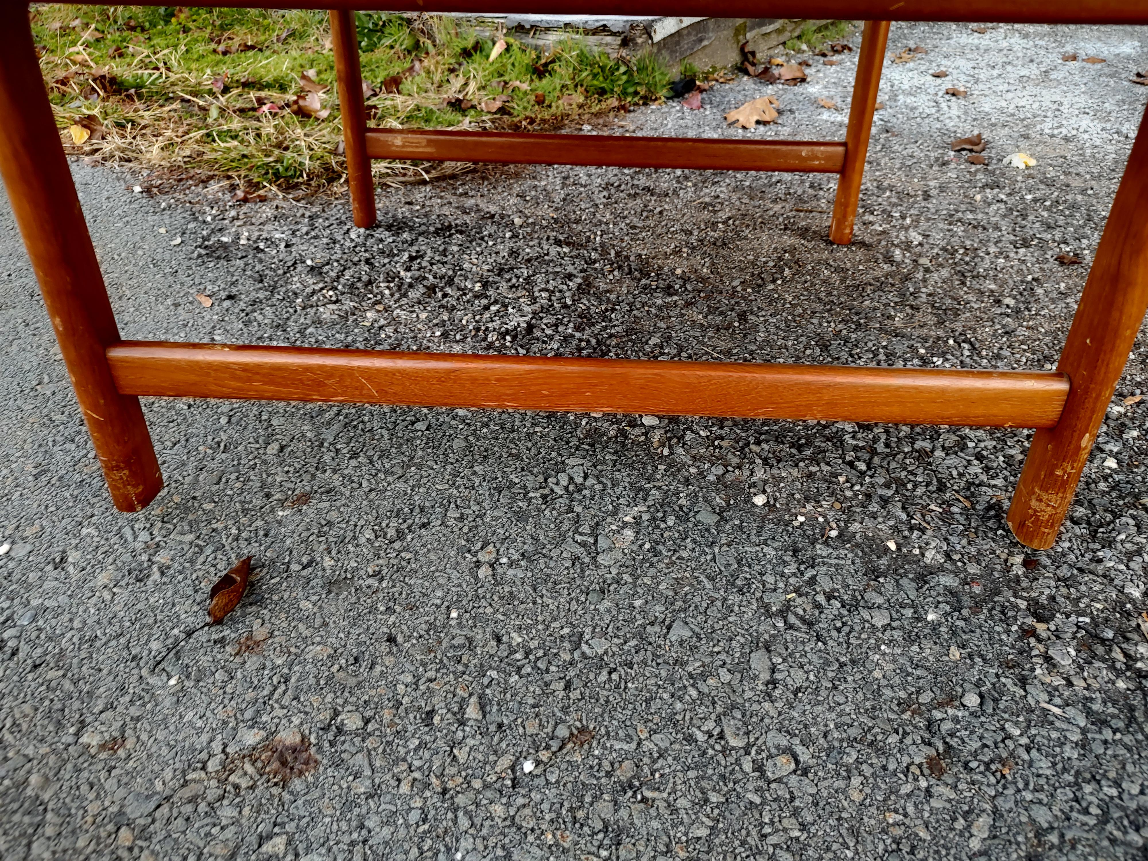 Fabulous round 42inch teak cocktail table by Dux with a removable reed woven shelf below, shelf is 20 x 22.5. In excellent vintage condition with minimal wear, a simple beautiful piece. Reed shelf is complete and simply rests on the tables