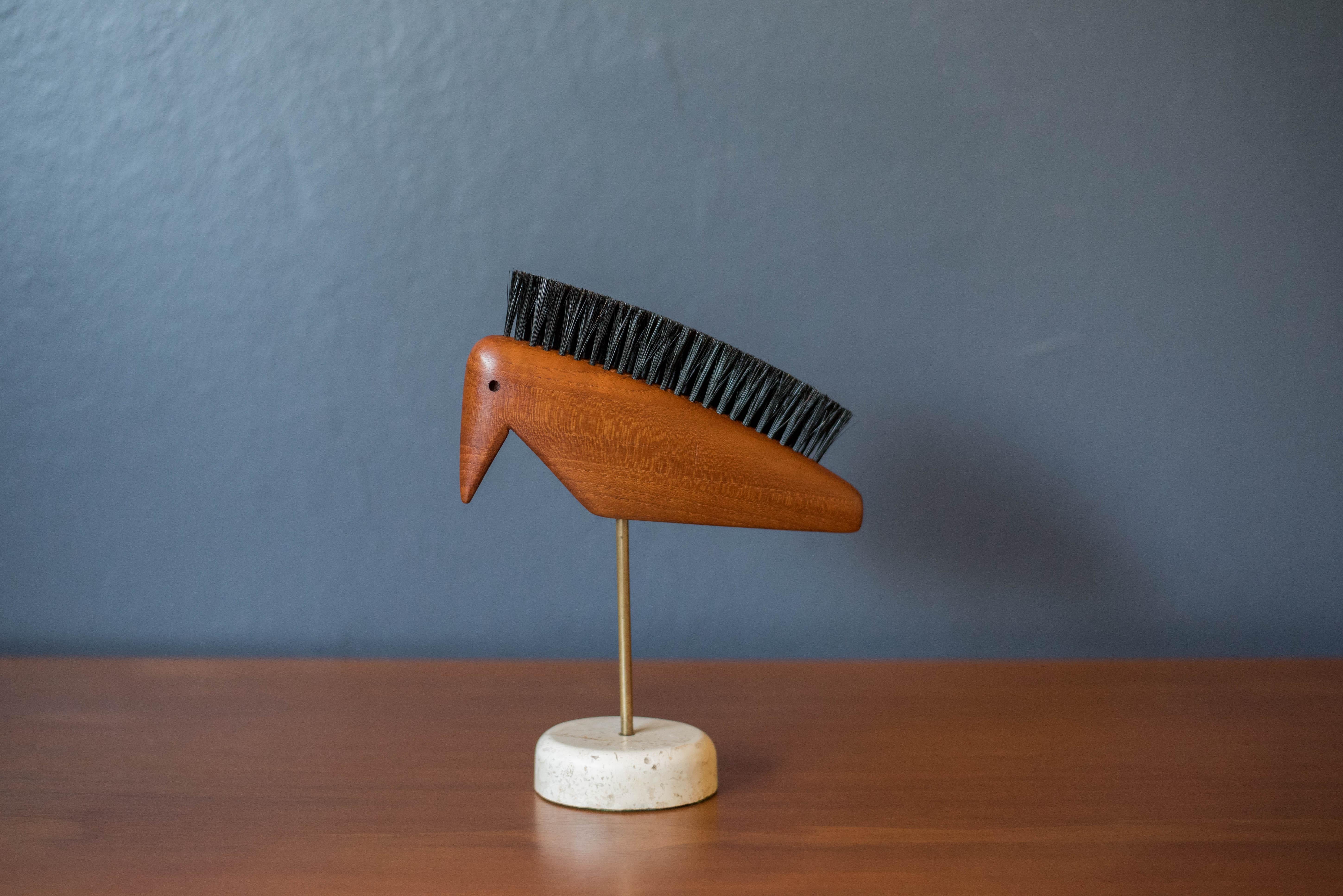 Vintage Danish modern abstract animal bird shoe brush in teak, circa 1960's. This piece has been very well kept and includes the hair bristles for cleaning. Sculpture is displayed on a travertine stone base. 