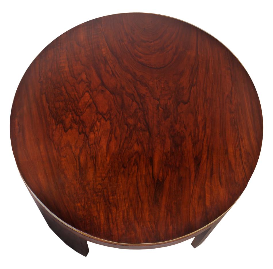 Mid-Century Modern round teak wood coffee or drinks table with brass border along the top, and tapered legs. European.