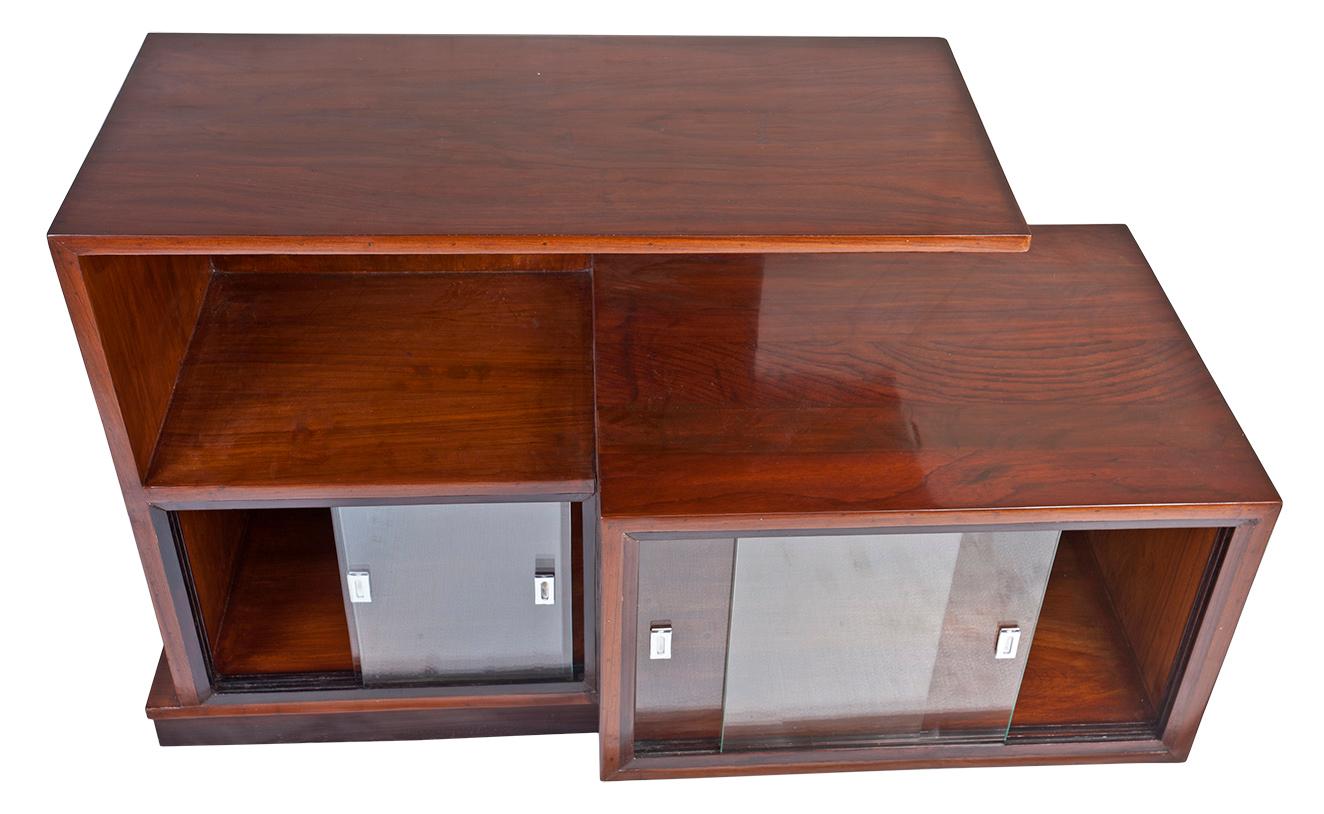 A multi-level Mid-Century Modern teak wood console credenza shelves with sliding glass panels on the lower level. The left side is 14