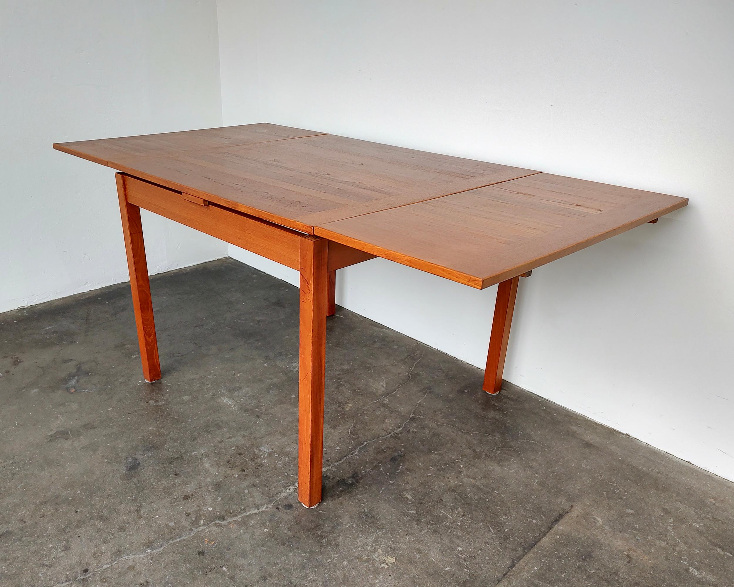 Danish mid-century modern teak wood dining table. Expands from square shape with hidden leaves underneath that slide open to longer rectangular shape. Overall great vintage condition, some light wear on legs. Legs can be detached for easy