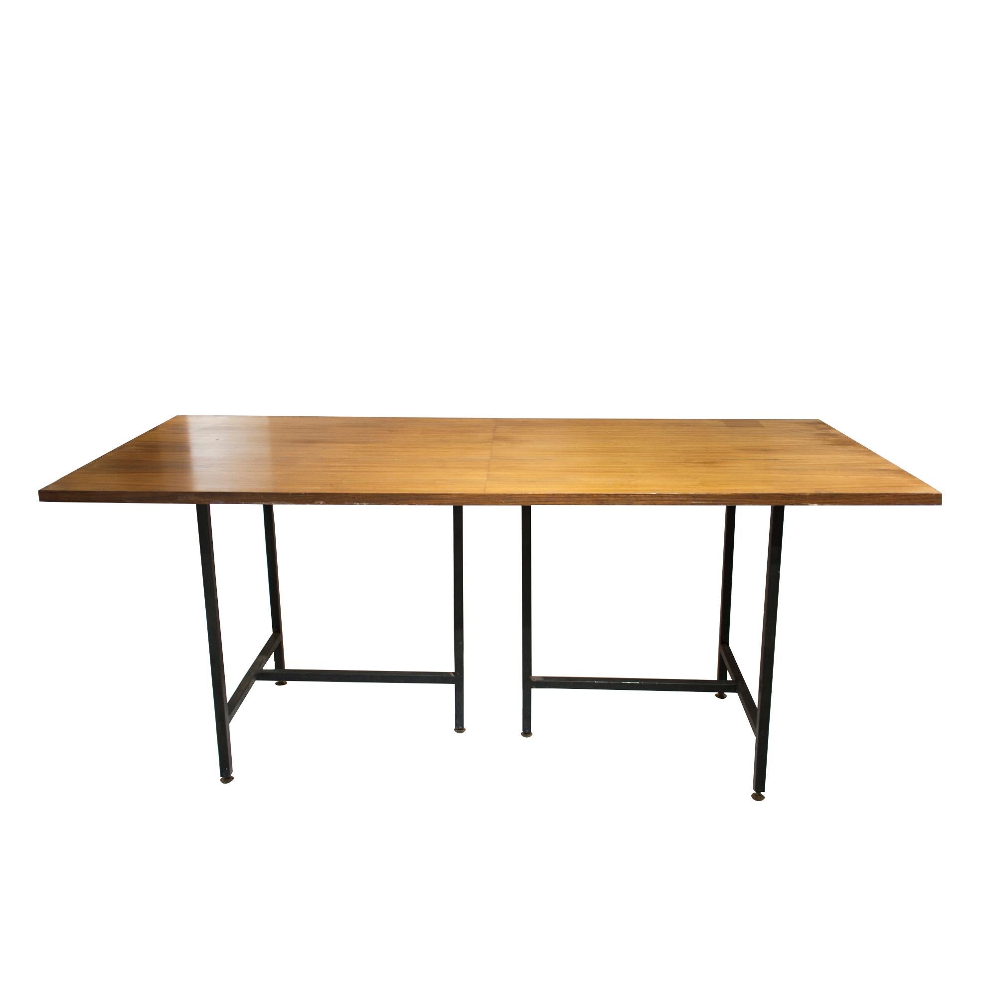 Mid- century modern Italian teak wooden desk with black lacquered iron base. The base consists of two independently moveable parts that can be modified according to the utilization of the desk. 

Dimensions: 180 x 80 x76 (H).

