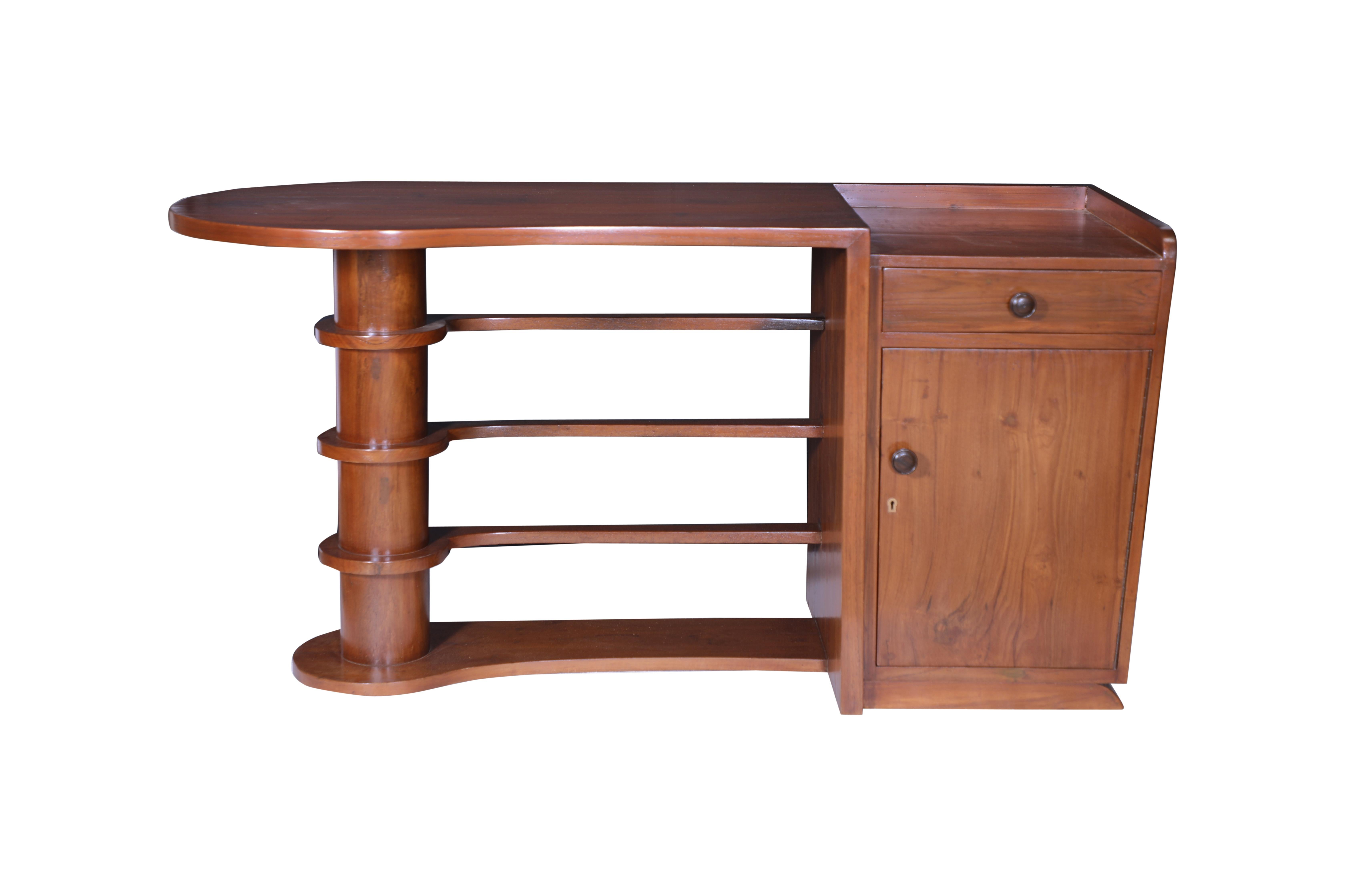 A stunning Mid-Century Modern teak writing desk or could also be used as a console table or as a sofa table.  Teak bars across the front as an architectural accent.  A right hand side cabinet with shelf and a top drawer.  The right side height is