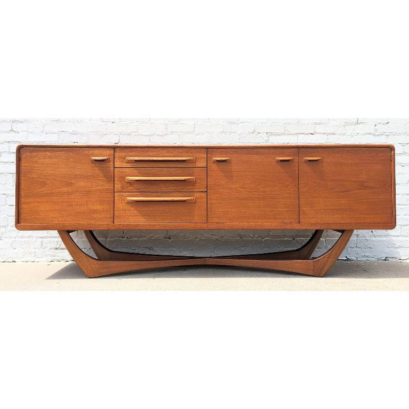 Mid Century Modern Teak X Base Credenza by Beithcraft

Above average vintage condition and structurally sound. Has some expected slight finish wear and scratching. Has a couple small dings and discolorations on top. Top right area of piece has some