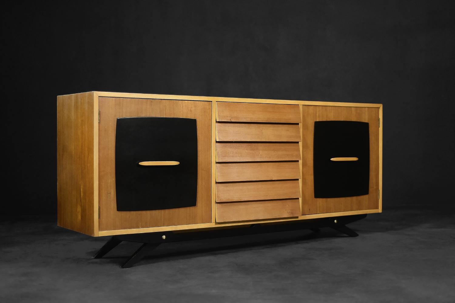 This modernist sideboard was designed by Gillis Lundgren for the Swedish company IKEA in 1955. The piece of furniture is part of the Forum series, which appeared in the company's catalog in 1956. The sideboard is made of teak wood in a warm shade of