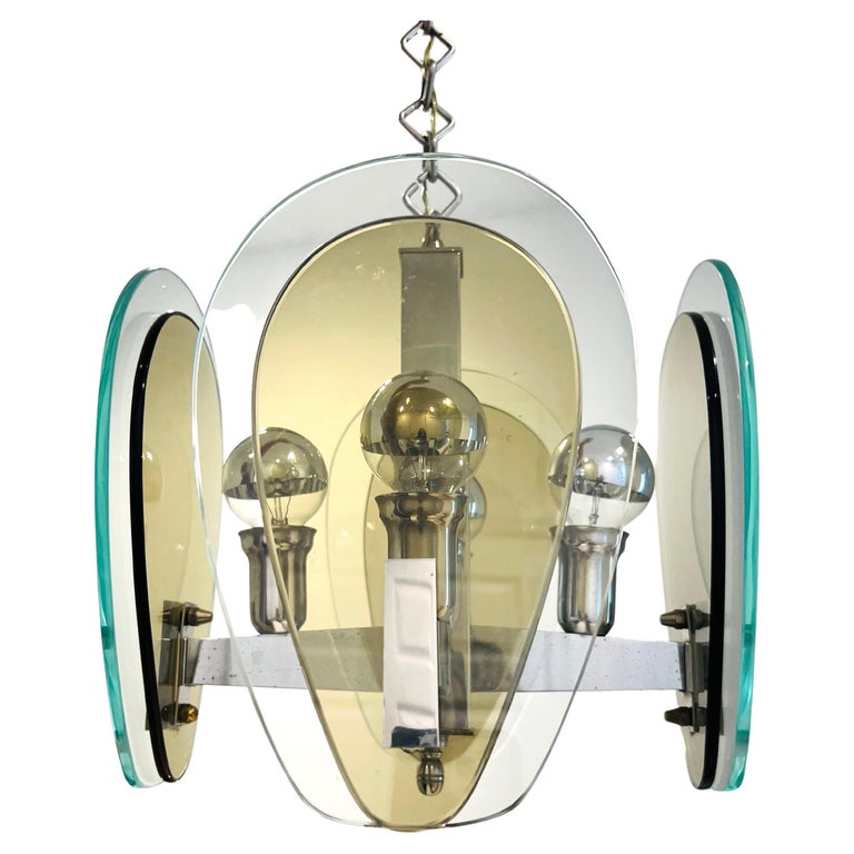Italian Mid-Century Modern four arm architectural pendant light. Chandelier has chrome frame fitted with double teardrop glass shades in hues of smoked gray and clear green. Has original diamond link chain and features stylized chromed fittings.