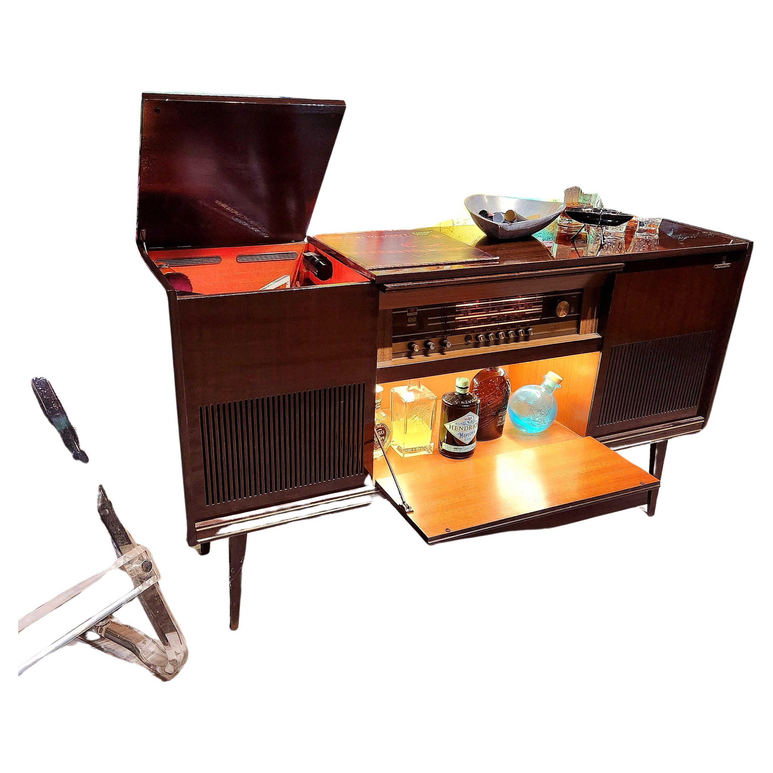 
“If art decorates space… and music is the art that decorates time, then our vintage stereo consoles decorate lives by accentuating both.”

This console:
This is a console refurbished by us.  We acquire our pieces from very reliable, established,