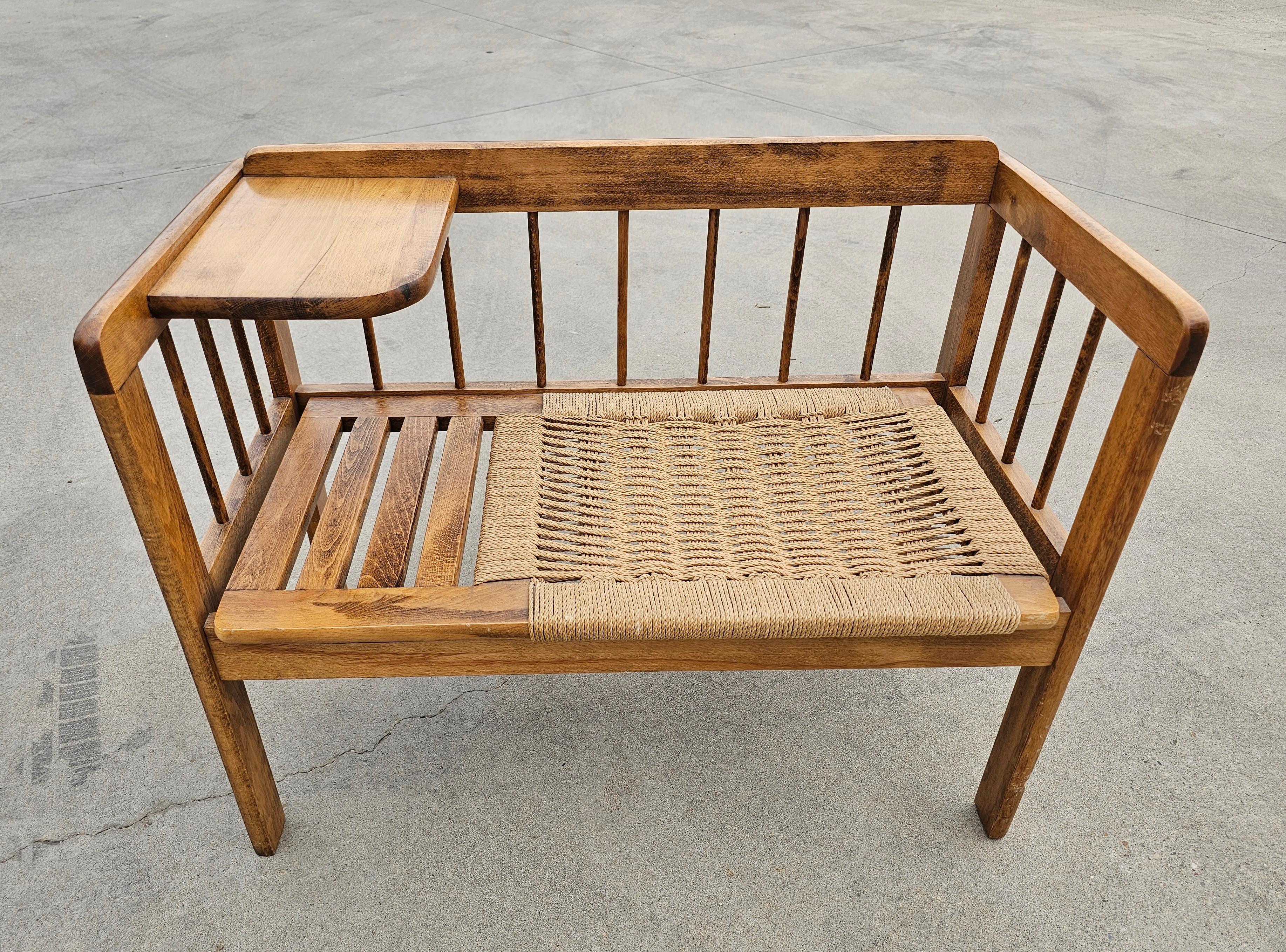 In this listing you will find an extremely rare Telephone Bench done in oak, with seats woven with Danish paper cord, designed in style of Hans J. Wegner. Also known as Gossip Bench, this unique piece of furniture works perfectly as the entryway