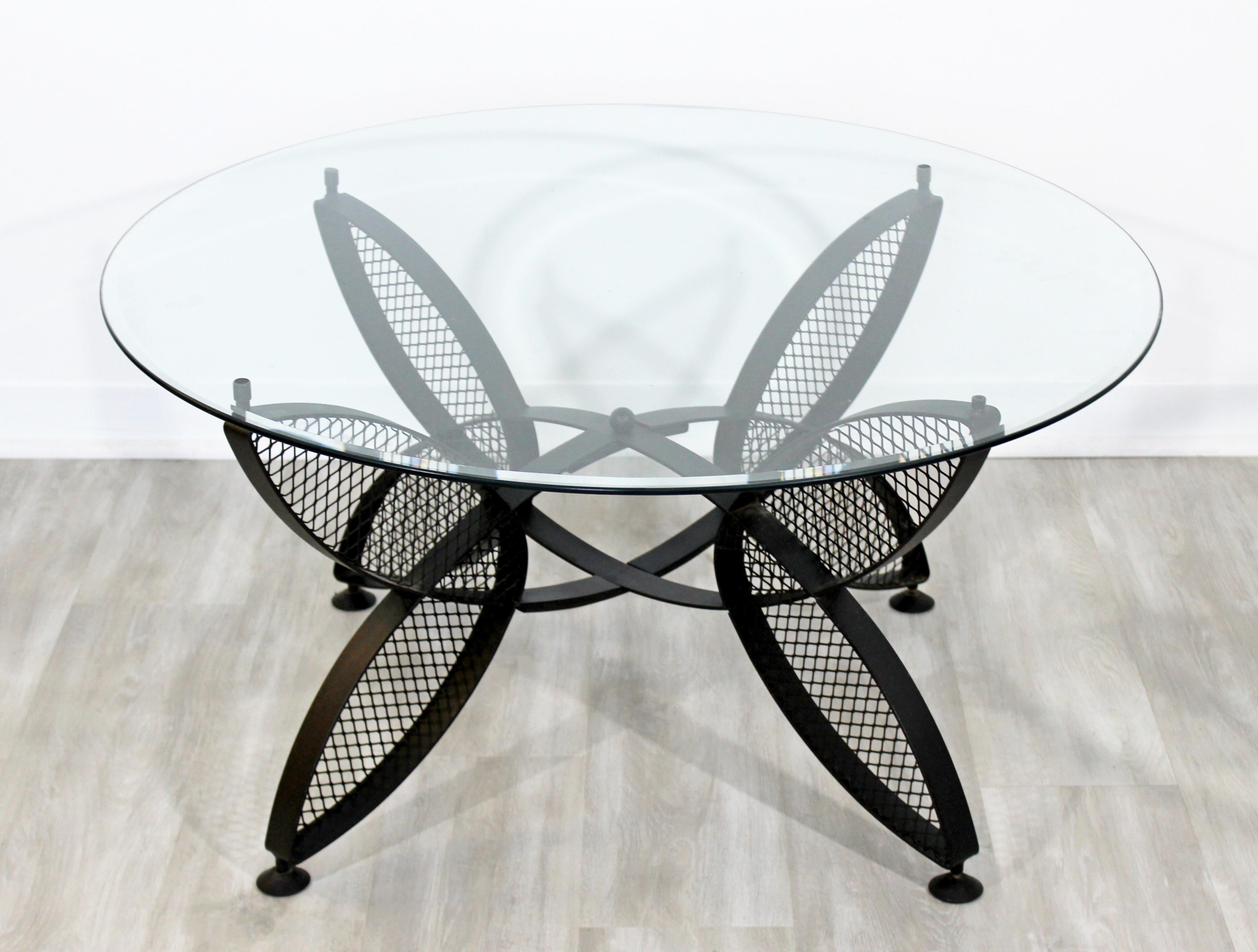 For your consideration is a fantstic, iron butterfly patio coffee table with a glass top, by Maurizio Tempestini for Salterini, circa t 1960s. In very good vintage condition. The dimensions are 38