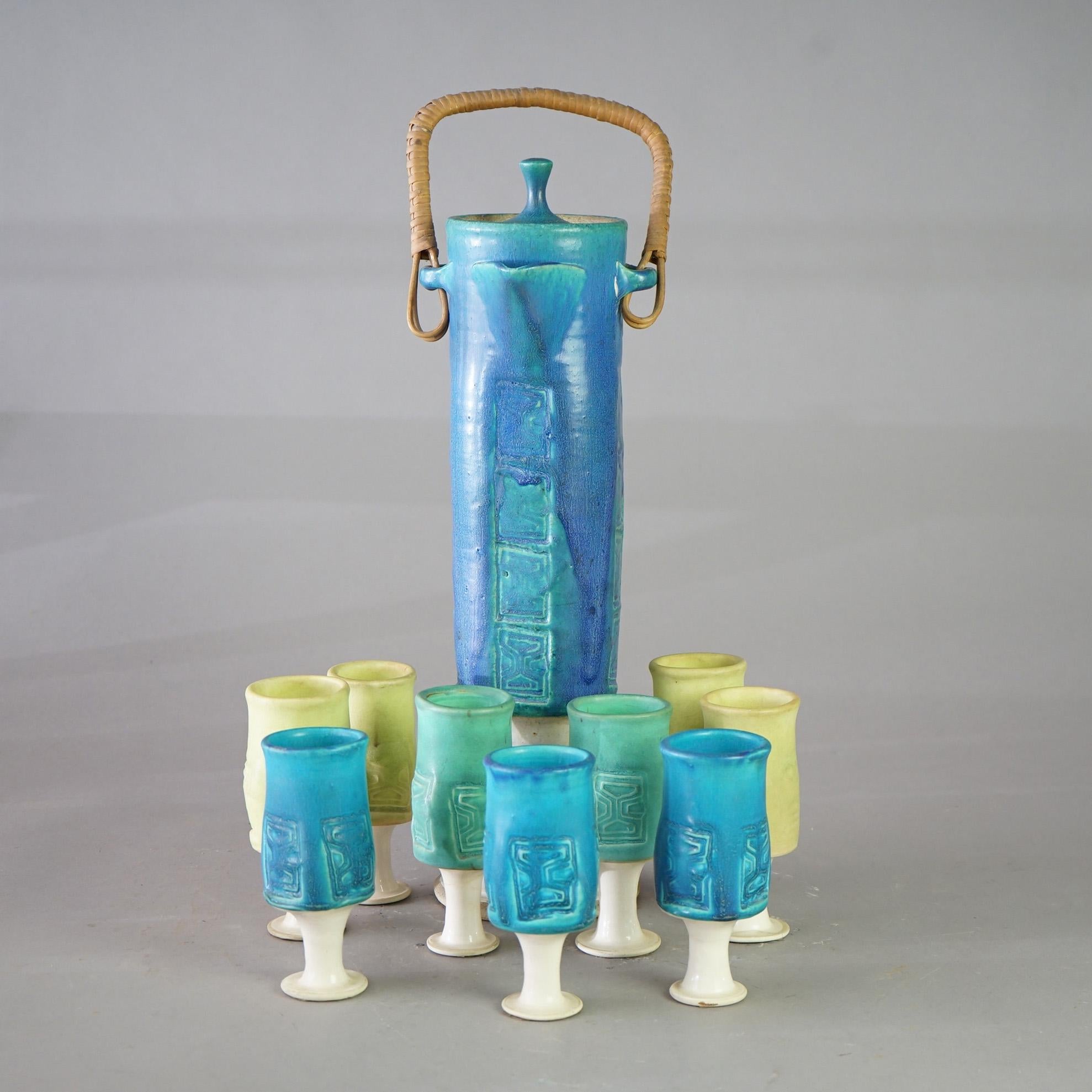 A Mid Century Modern cider set offers hand thrown studio art pottery construction with footed pitcher and cups, c1960

Measure - 20.5
