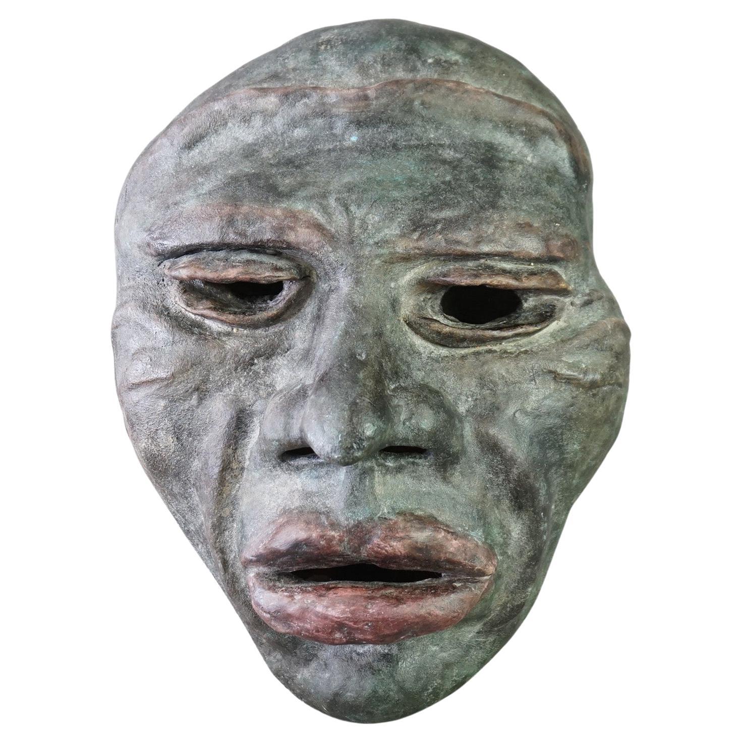 A Mid Century Modern wall sculpture by York offers terra cotta construction and depicts the face of a tribal man, artist signed, c1997

Measures - 14.75