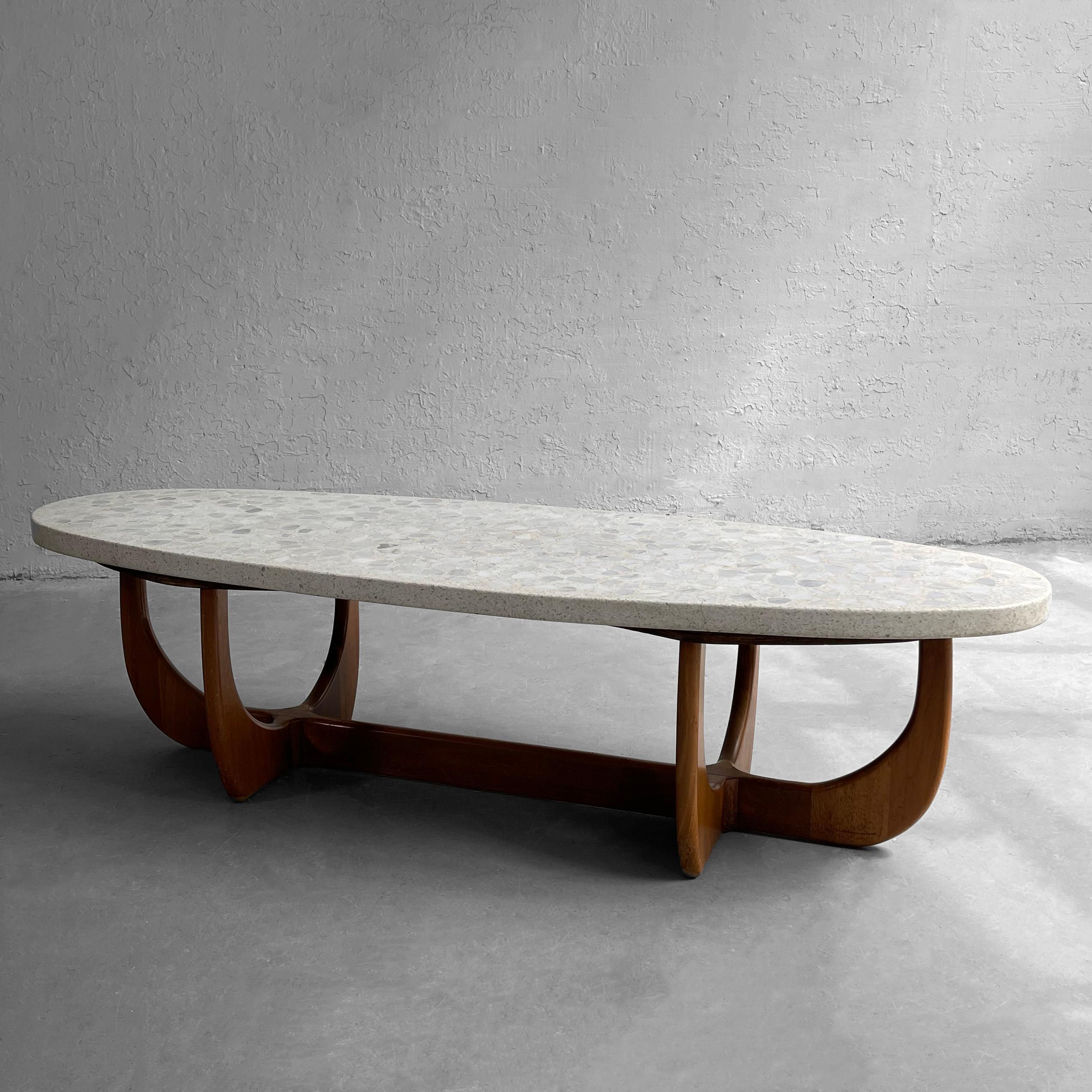 Mid-Century Modern, coffee table by Harvey Probber features an oblong, oval, terrazzo stone top with sculptural walnut base.