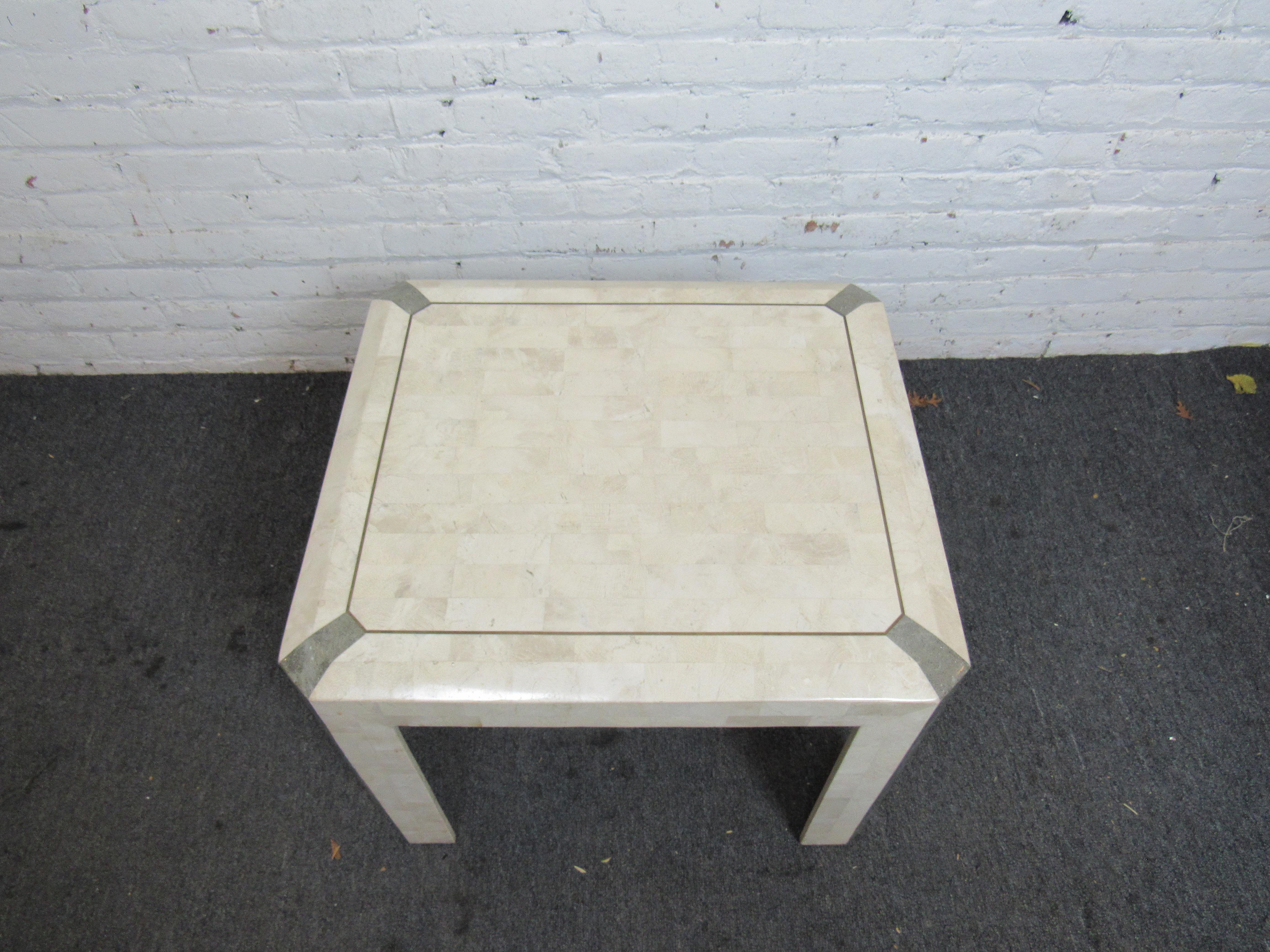 Unusual tessellated stone side table. Beautiful finish throughout with nice gray stone inlays.
