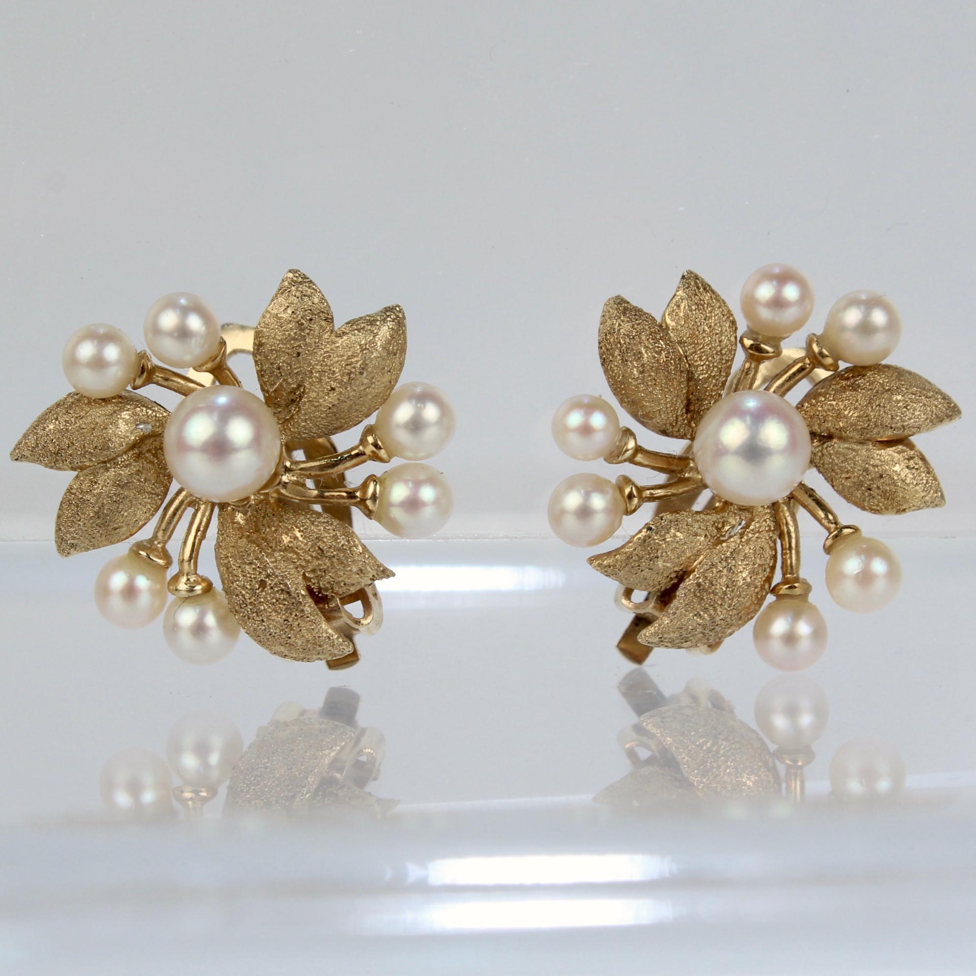 A fine pair of mid-century modern gold & pearl clip on earrings.

In the form of a stylized flower with textured 14k yellow gold petals and a pearl set center and stamens.

Simply wonderful Mid-century earrings!

Date:
Mid-20th Century

Overall