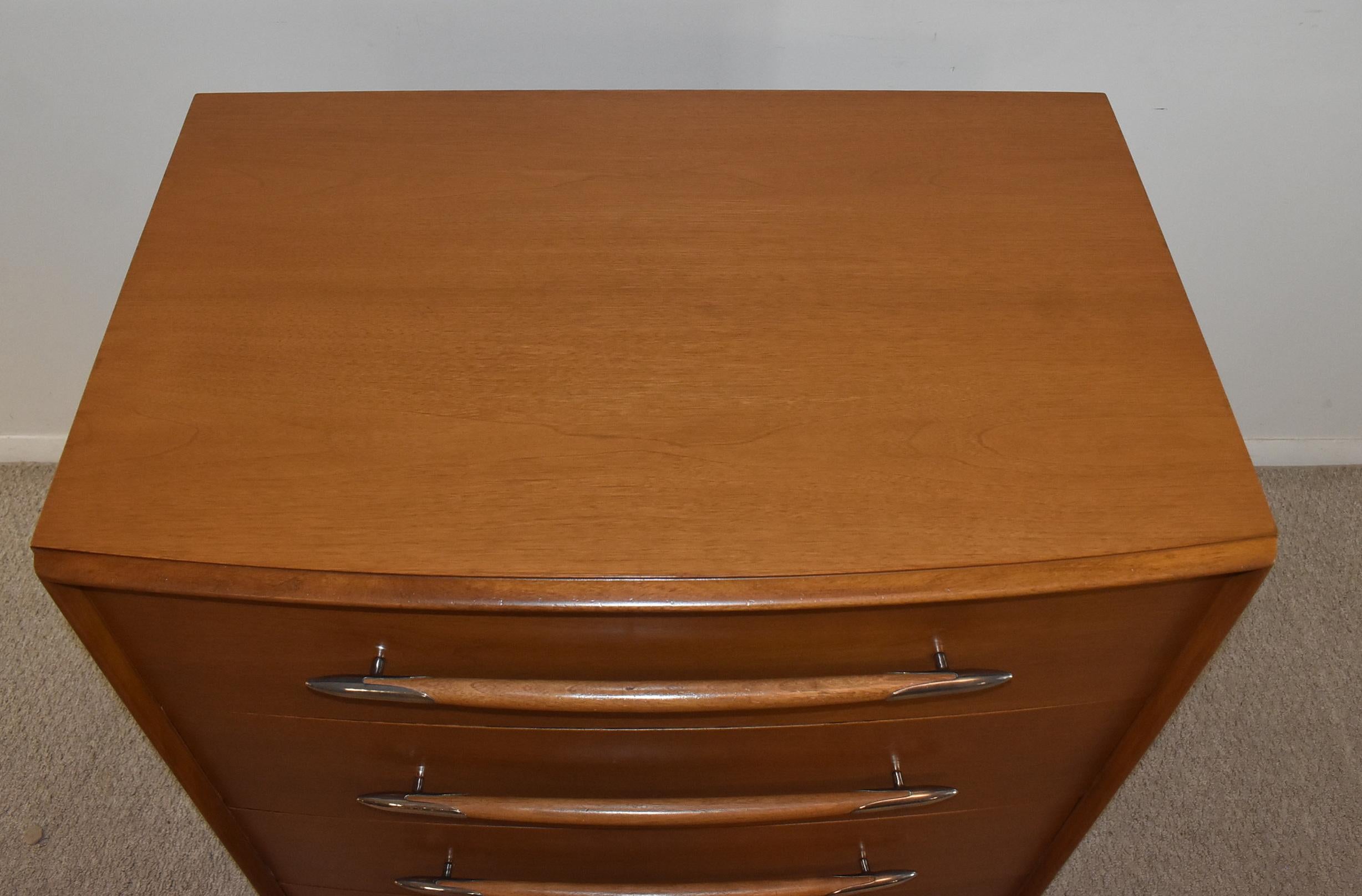 Elegant mid-century modern walnut dresser by T.H. Robsjohn-Gibbings for Widdicomb features a curved front, captivating spear-shaped silver finish tipped pulls, and 4 drawers. 34