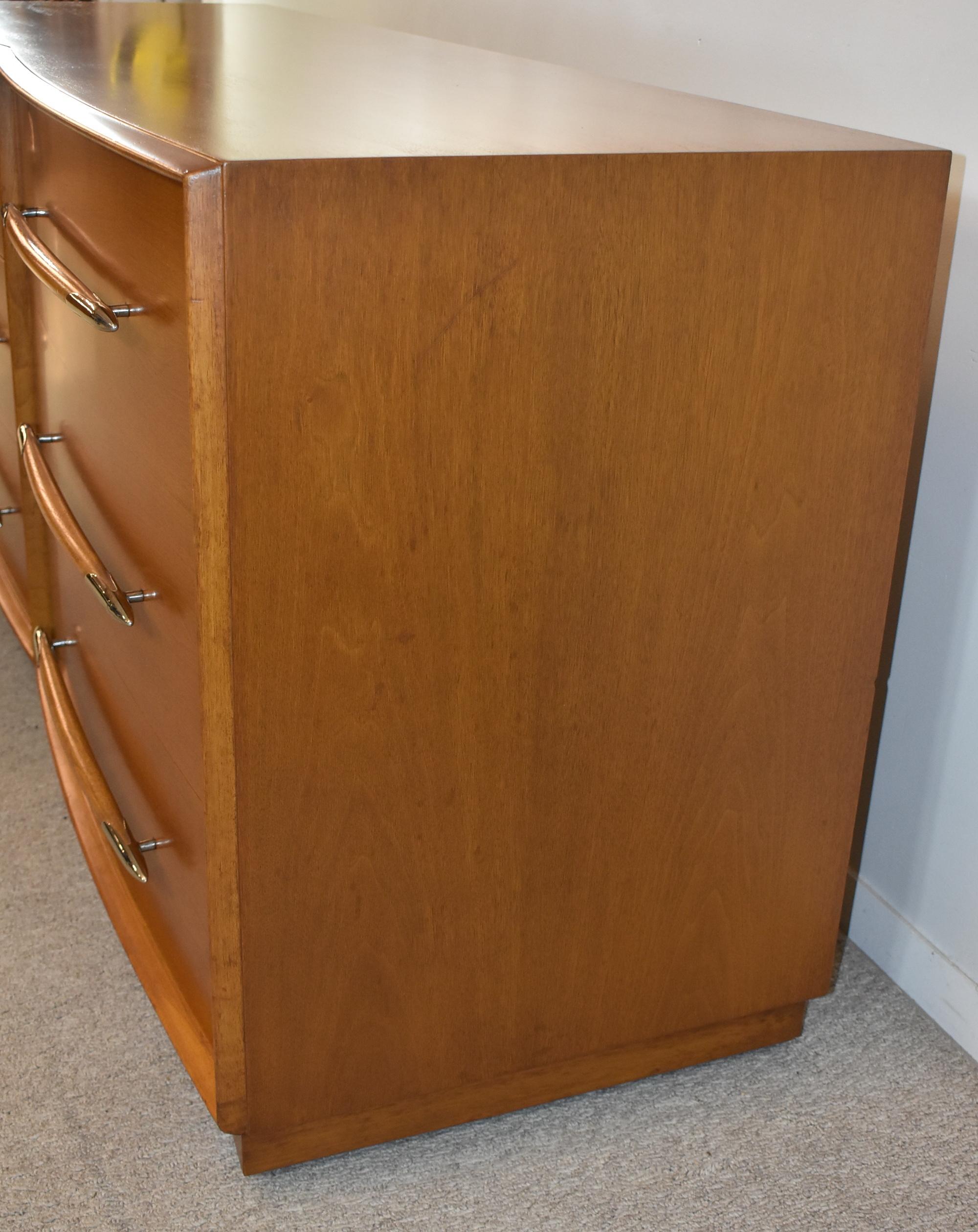 Elegant mid-century modern walnut dresser by T.H. Robsjohn-Gibbings for Widdicomb features a curved front, captivating spear-shaped silver finish tipped pulls, and 6 deep drawers with dividers. 67