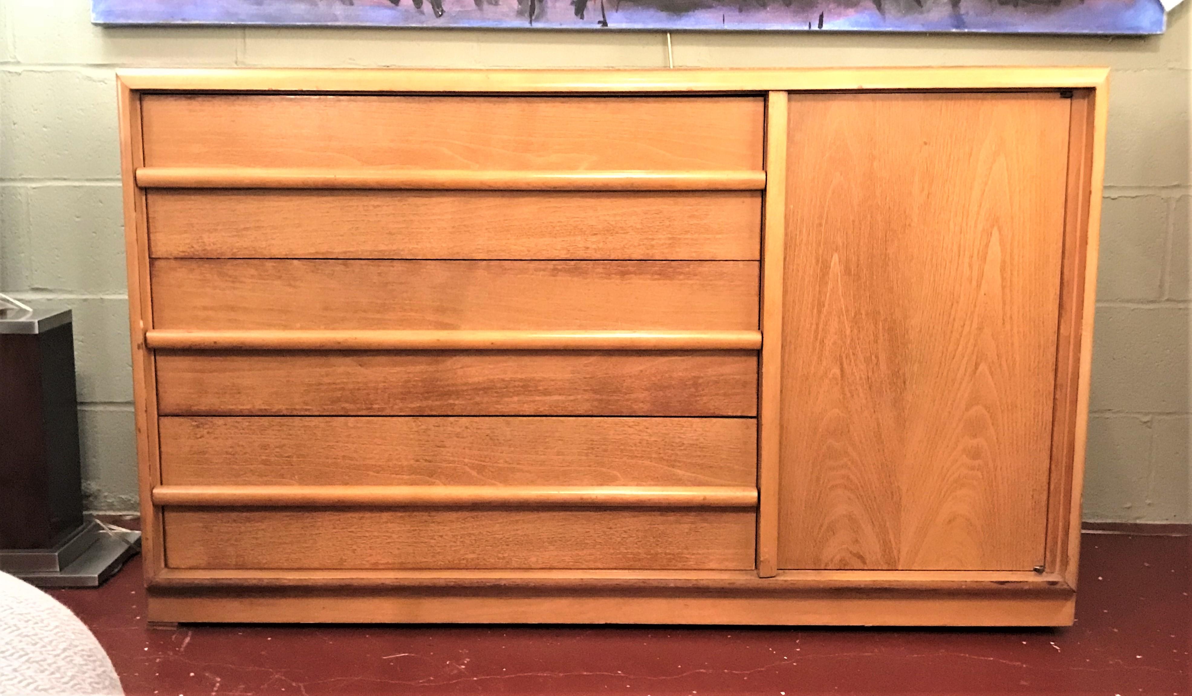 TH Robsjohn-Gibbings three drawers chest with side door bearing the Widdicomb label. This sleek and stylish Mid-Century Modern chest sits on casters and is certain to make a wonderful addition to any collection.