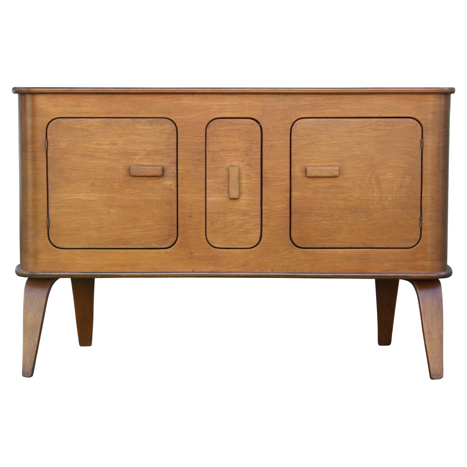 Lovely Mid-Century Modern credenza / sideboard designed by Herbert Von Thaden for Thaden Jordan. Made from molded birchwood. This piece features two open cabinet spaces and a centre drawer.