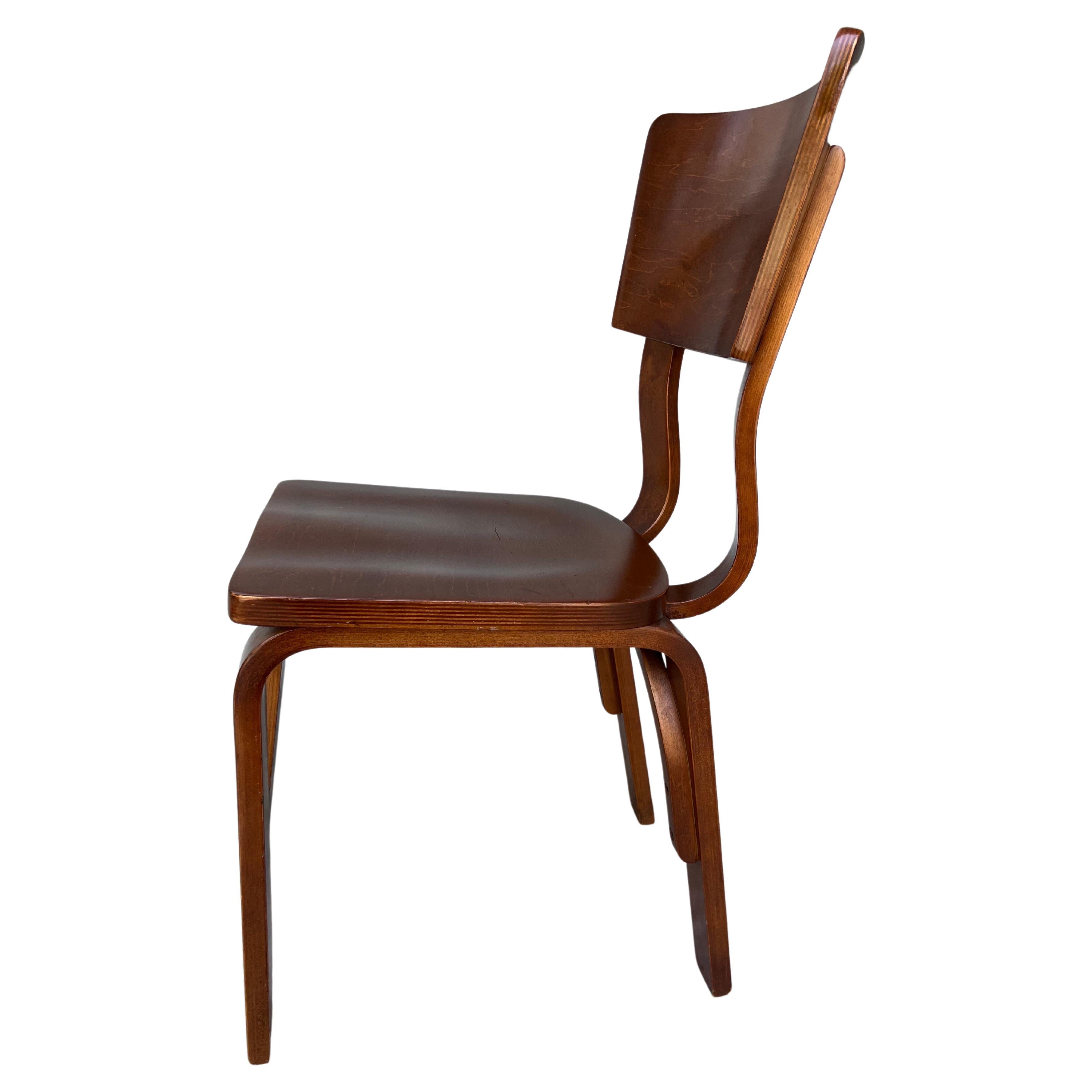Perfectly patinaed bentwood Thonet chair. This chair is stately, classic, comfortable, and sturdy. Constructed from modeled bent plywood and finished with a walnut stain. This is the perfect chair for your office or to complete a dining set. Make it
