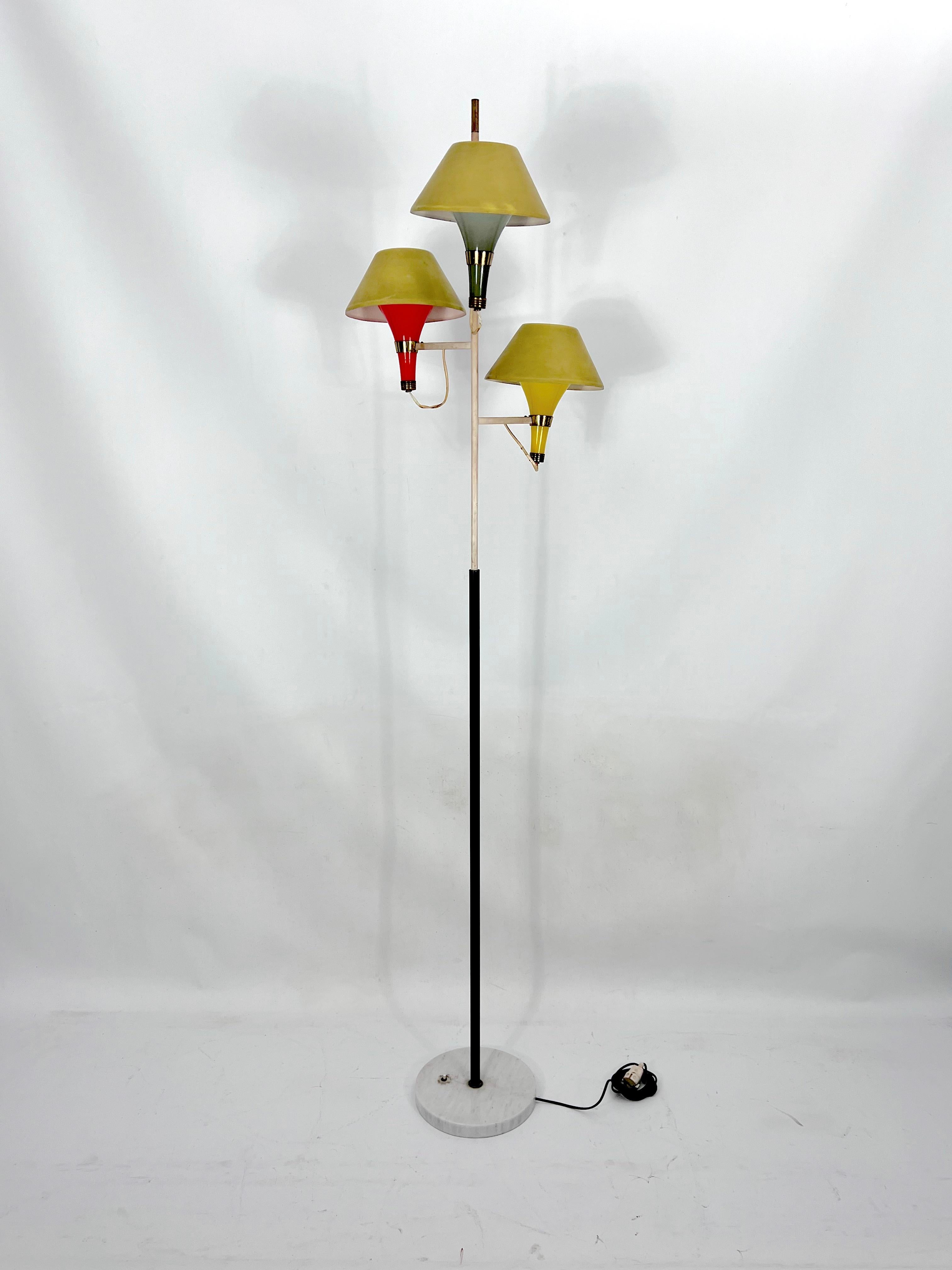 Rare three arms floor lamp produced by Stilux Milano during the 50s. Marble base with lacquered metal stem and brass details. Three arms with colored murano glass light diffusers and lacquered aluminum hats on top. Fair original vintage condition