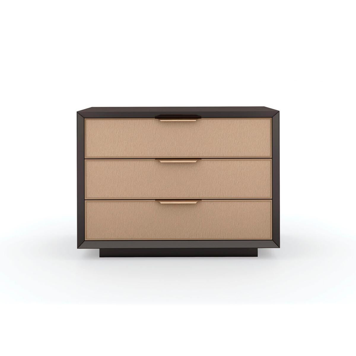 Mid Century Modern Three Drawer Nightstand, a clean-lined nightstand merges minimalism with elements of mid-century modern design. Framed in a contrasting Dark Chocolate finish, three soft-closing drawers feature textured vinyl fronts, embossed with