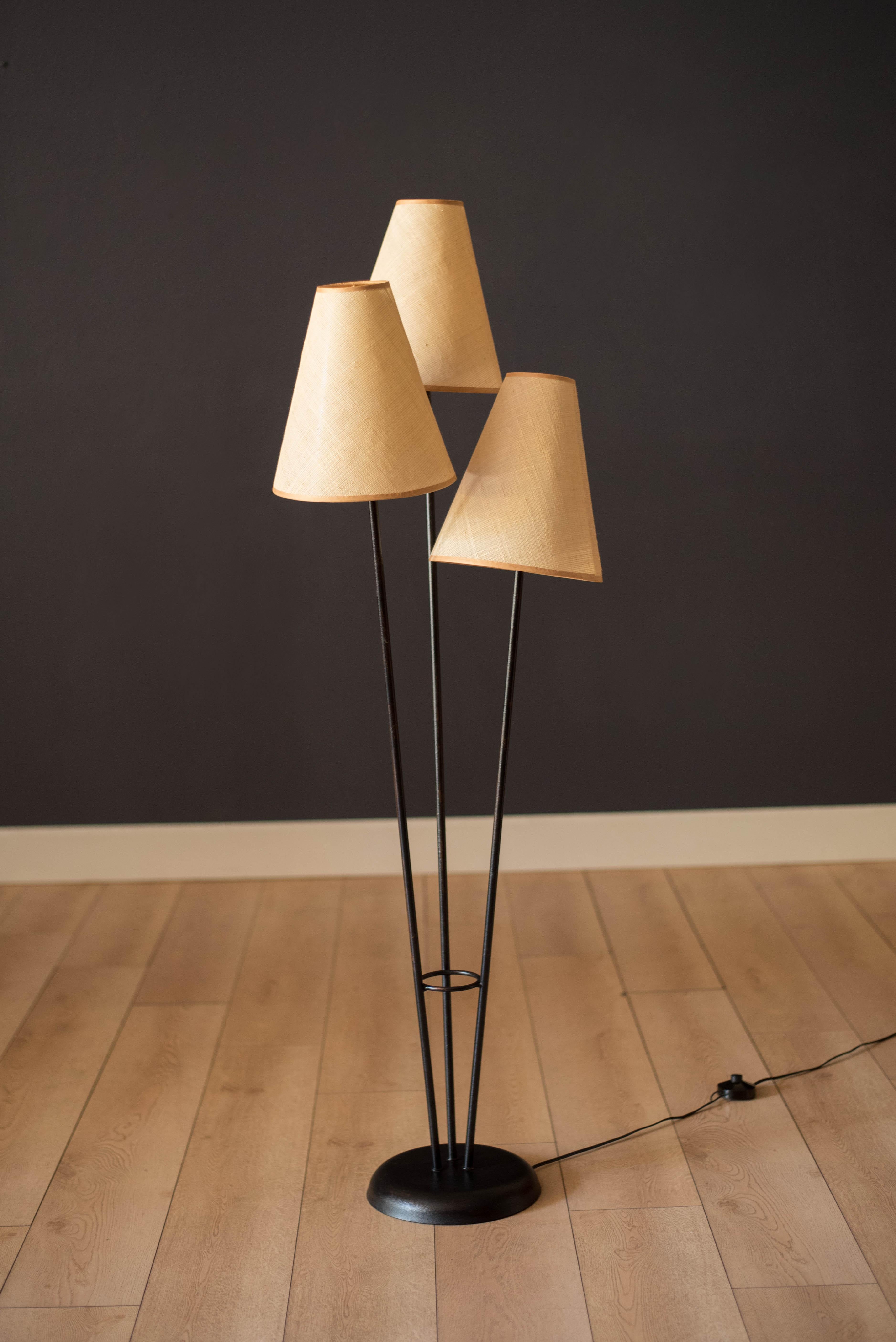 Classic vintage triple light floor lamp circa 1960's. This unique piece features three tapered natural woven fiber shades that emits a soft warm glow. Supporting base is made out of metal construction finished in a textured black enamel.




Offered