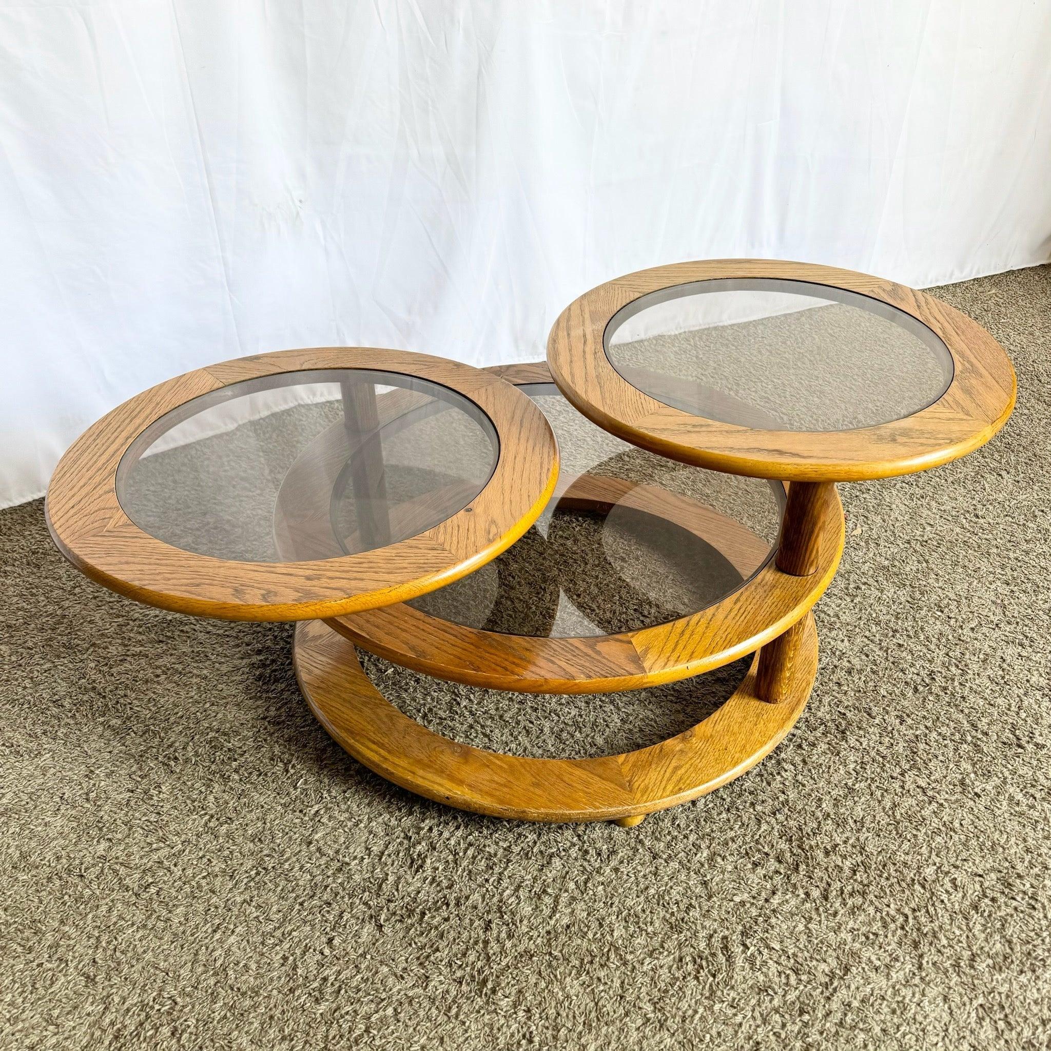 Mid-Century Modern Three-Tier Swivel Coffee Table—oak frame with smoked glass surfaces adds vintage sophistication to interiors.​
 
 Some wear to the wood and finish as shown in the photos.
 
 We sell items as acquired, without restoring or