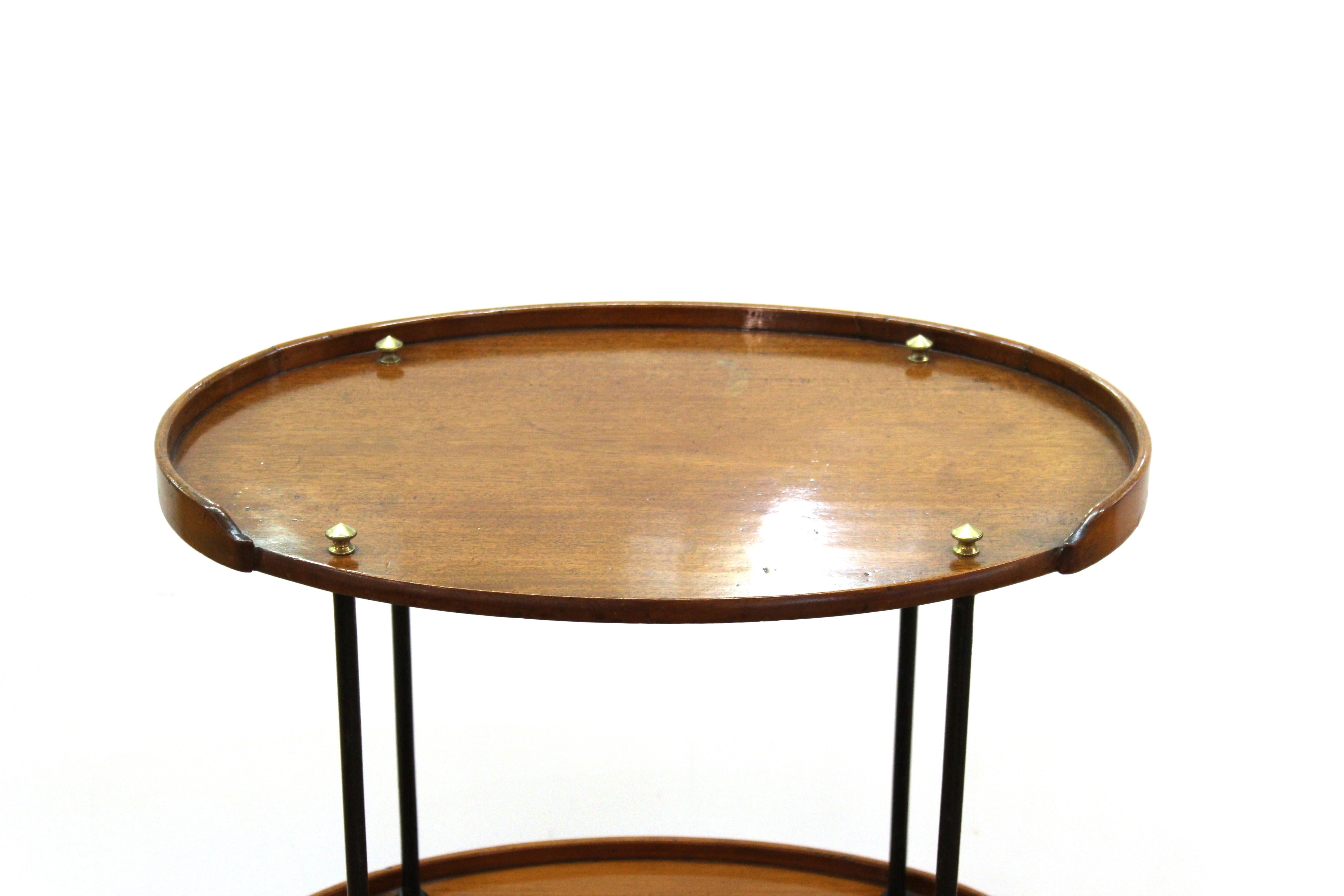 Mid-Century Modern mixed wood bar cart or étagère, the three oval tiers with ebonized column supports. Measures: 34” H x 24.5” W x 17.5” D.