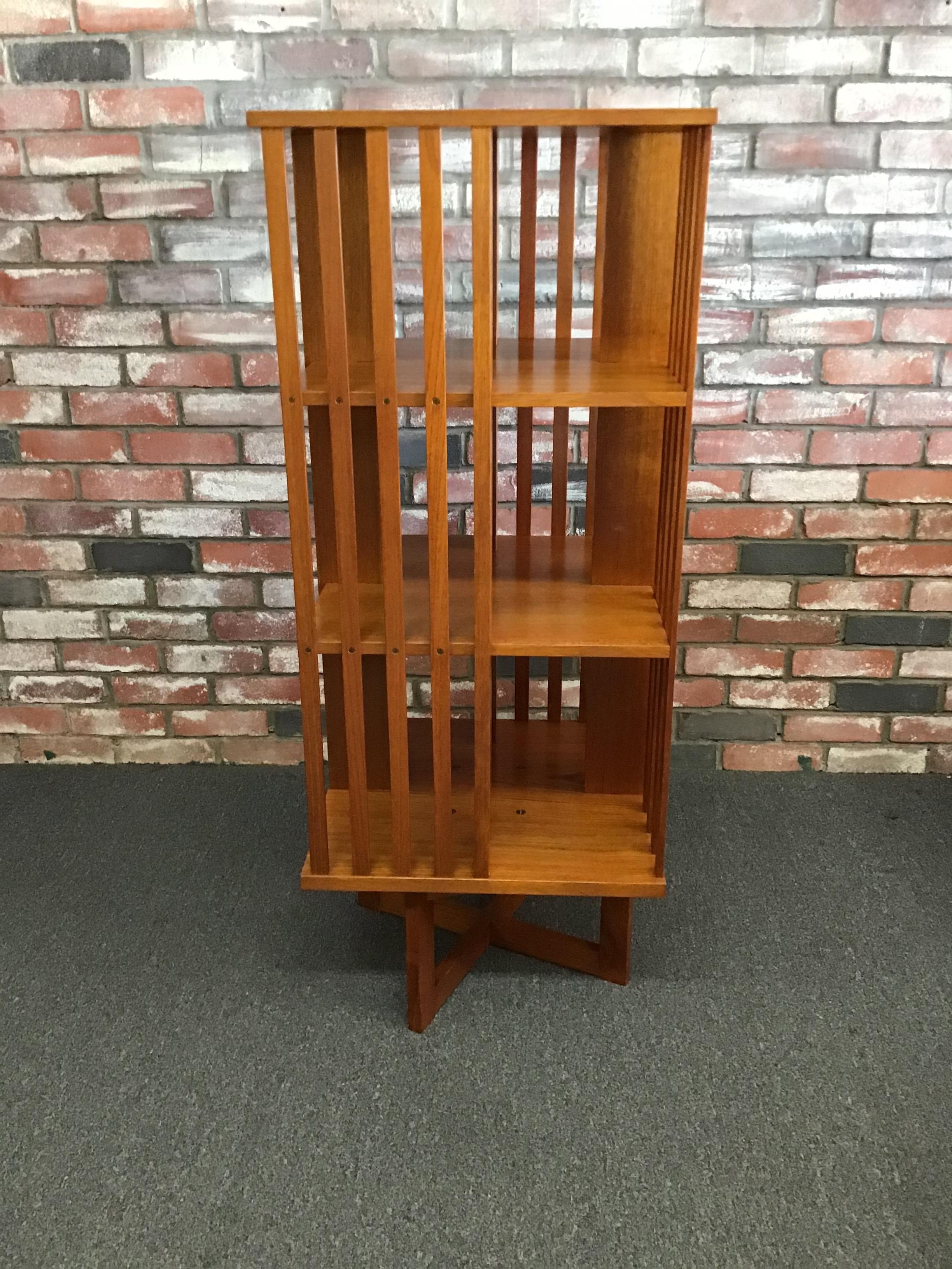 Mid-Century Modern three-tier revolving teak bookcase, circa 1970s. This bookcase is a very practical piece for any room in the house. The case holds a ton of books in an efficient compact manner, the top shelf is 10.5