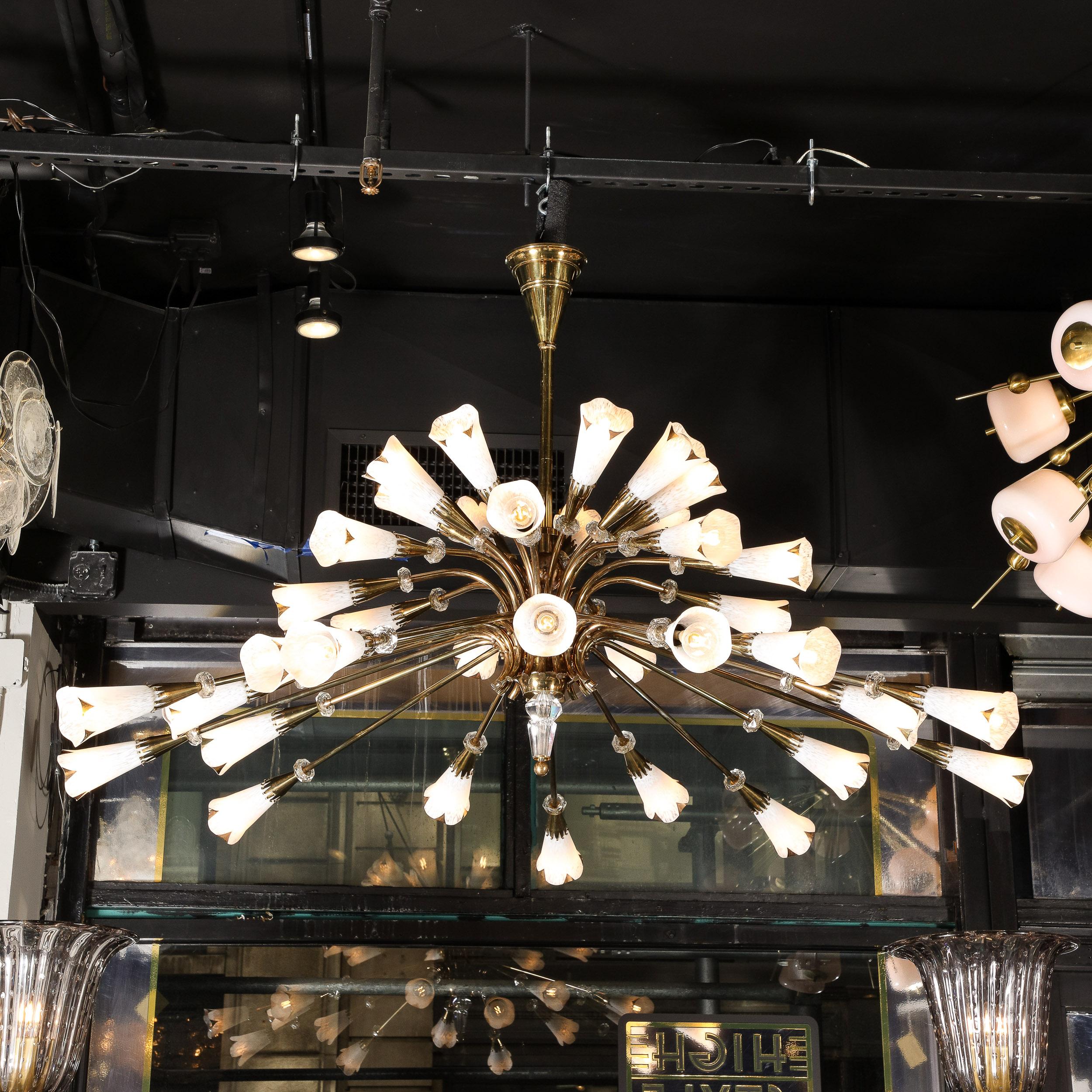 This dramatic and gorgeous Mid Century Modern chandelier was realized in France circa 1950. It offers an abundance of polished brass rods that affixed- via round brass rivets- to a central stem appearing like a glossy stylized tree with an exploding