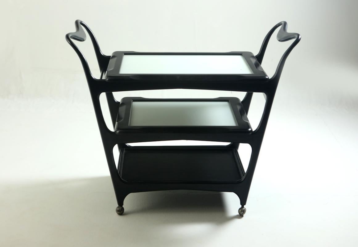 Mid-Century Modern three-tier tea cart by Teperman Manufacture in Ebonized Pink Peroba Hardwood, Brazil 1950s.

This elegant black and white three-tier tea-cart or bar-cart was produced in the 1950s by Teperman Manufacture. It features two