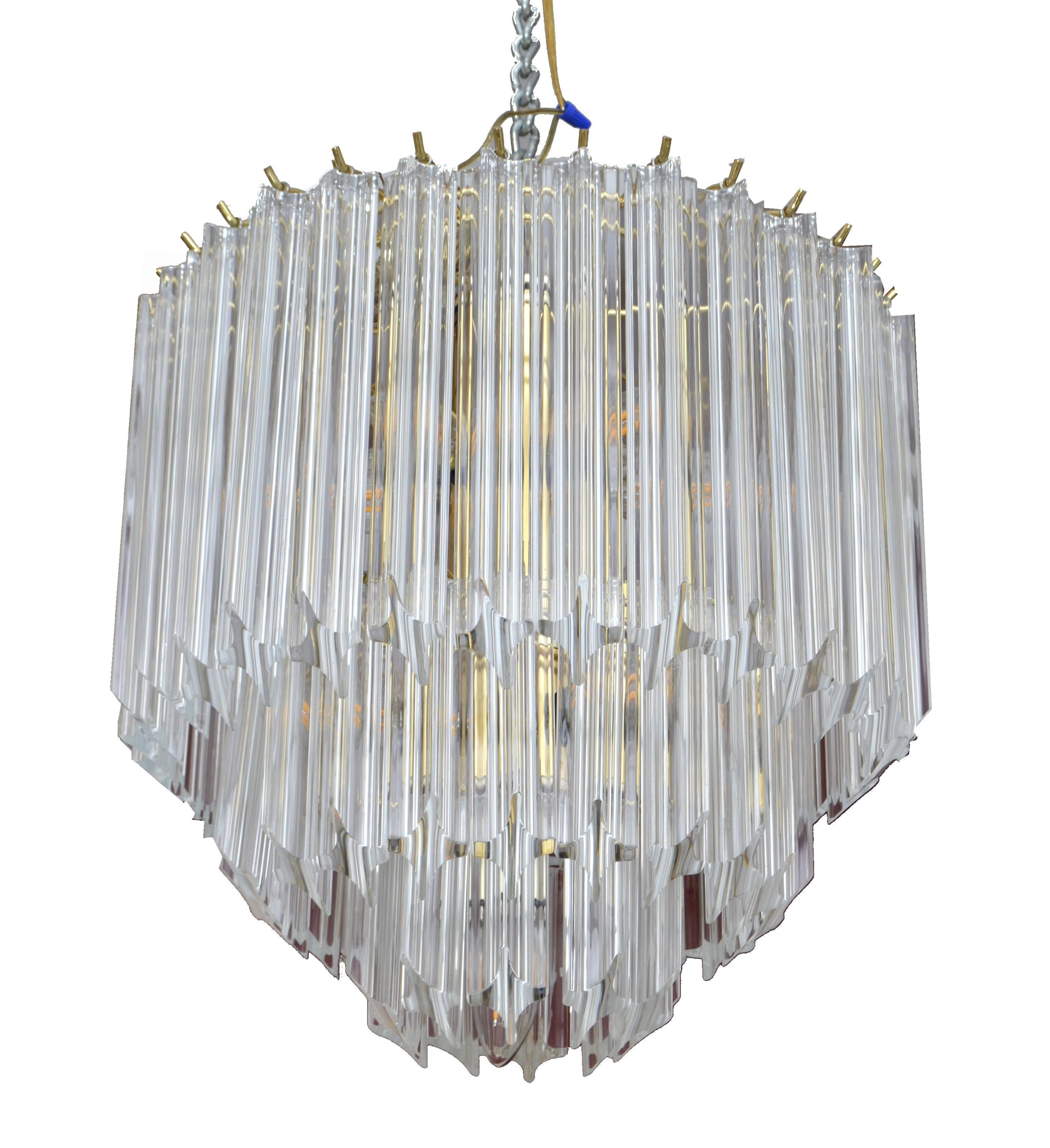 Mid-Century Modern brass and Lucite chandelier.
The Lucite Prisms have three different sizes and will be hung on three different levels, very impressive when it is hanging.
In perfect working condition and uses ten light bulbs, max. 25 watts, we use