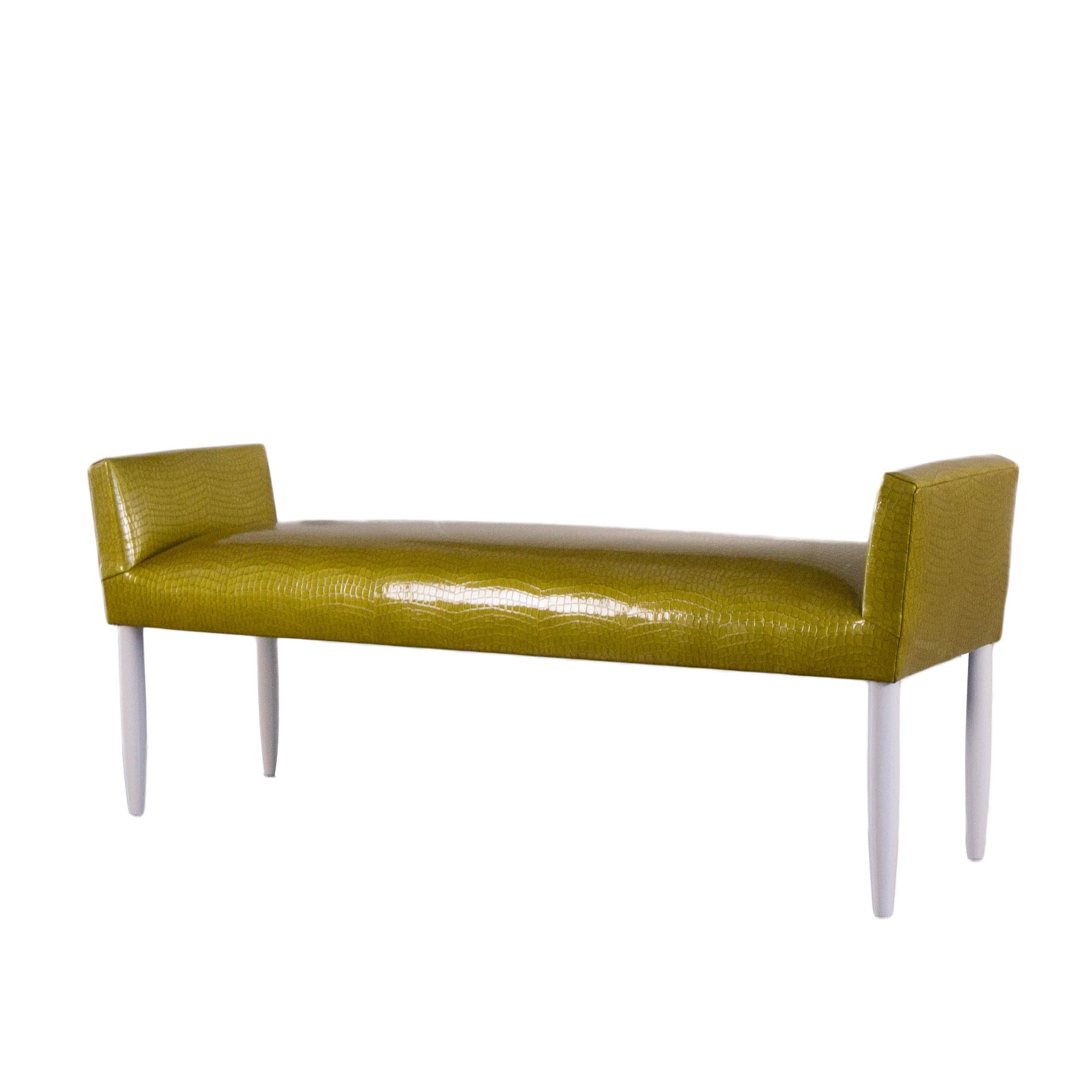 Inspired by Mid-Century Modern furniture, this tight cushioned accent bench is built to order and completely customizable. The bench shown was custom made featuring a green textured vinyl with a Mid-Century Modern tapered legs style painted in white