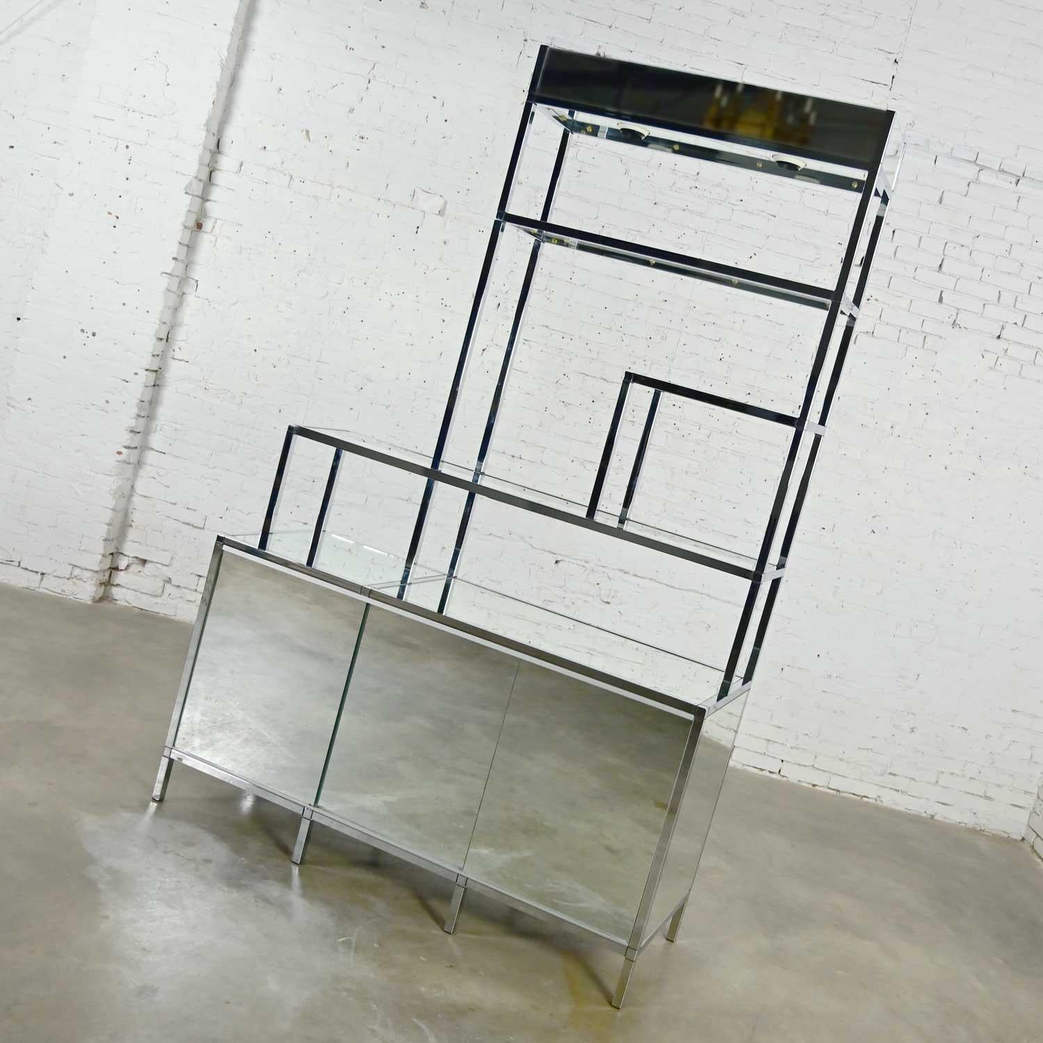 Stunning vintage mid-century modern to modern chrome & mirrored one-piece etagere or room divider with lower enclosed cabinet portion in the style of DIA or Ello. Beautiful condition, keeping in mind that this is vintage and not new so will have