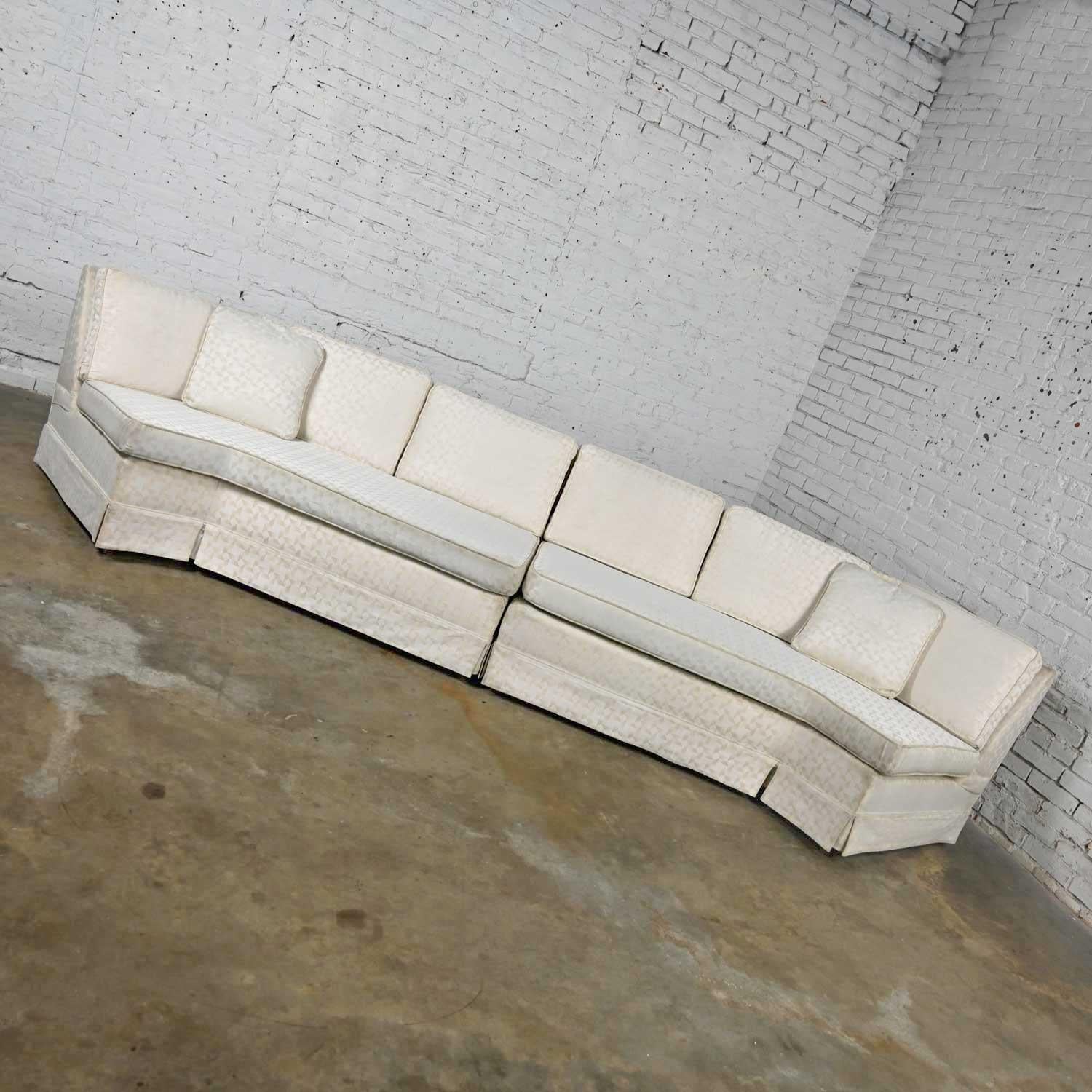 Stunning Mid-Century Modern to modern & Hollywood Regency white fabric two piece angled sectional sofa with square tapered wood legs. Beautiful condition, keeping in mind that this is vintage and not new so will have signs of use and wear. It has
