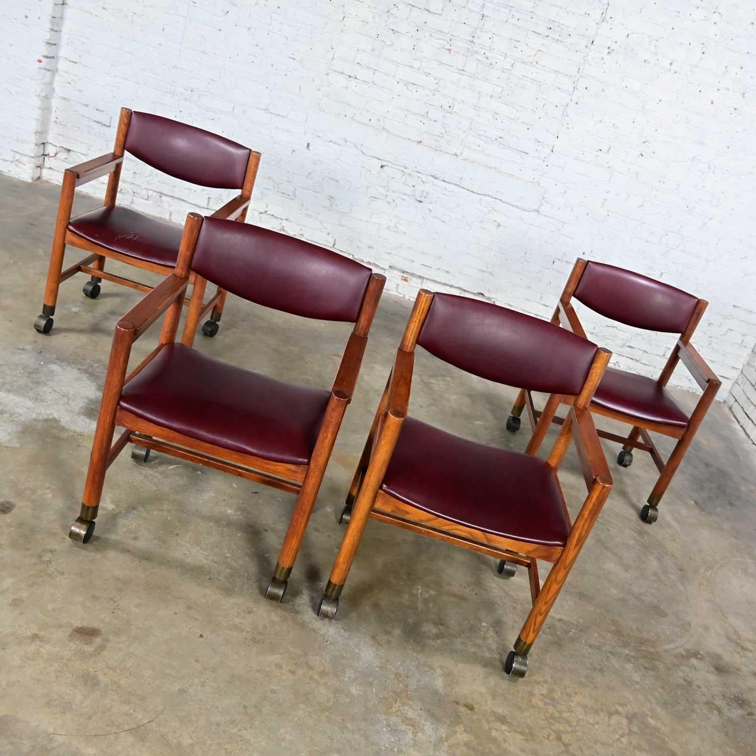 Unknown Mid-Century Modern to Modern Oak Maroon Vinyl Rolling Game or Dining Chairs For Sale