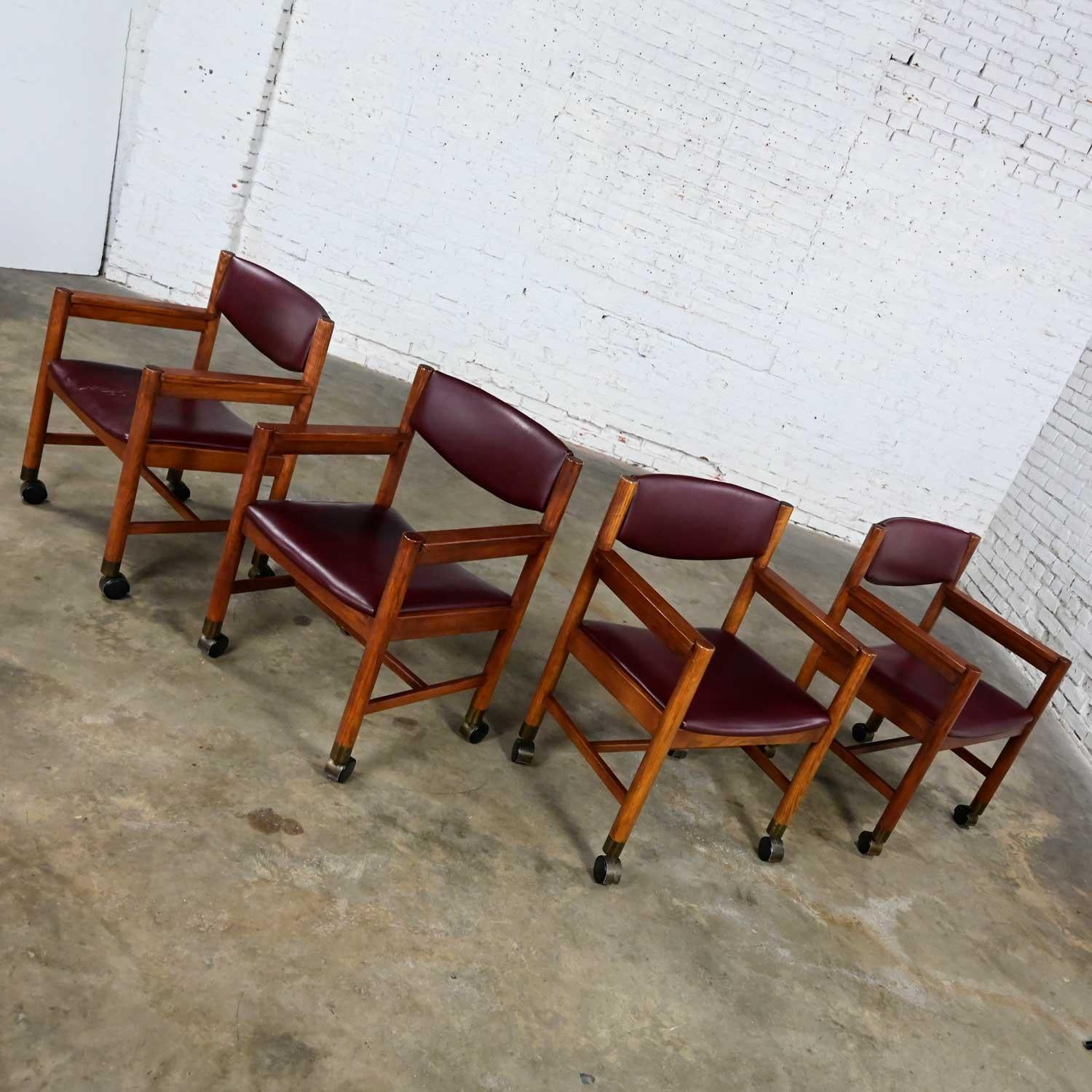 20th Century Mid-Century Modern to Modern Oak Maroon Vinyl Rolling Game or Dining Chairs For Sale