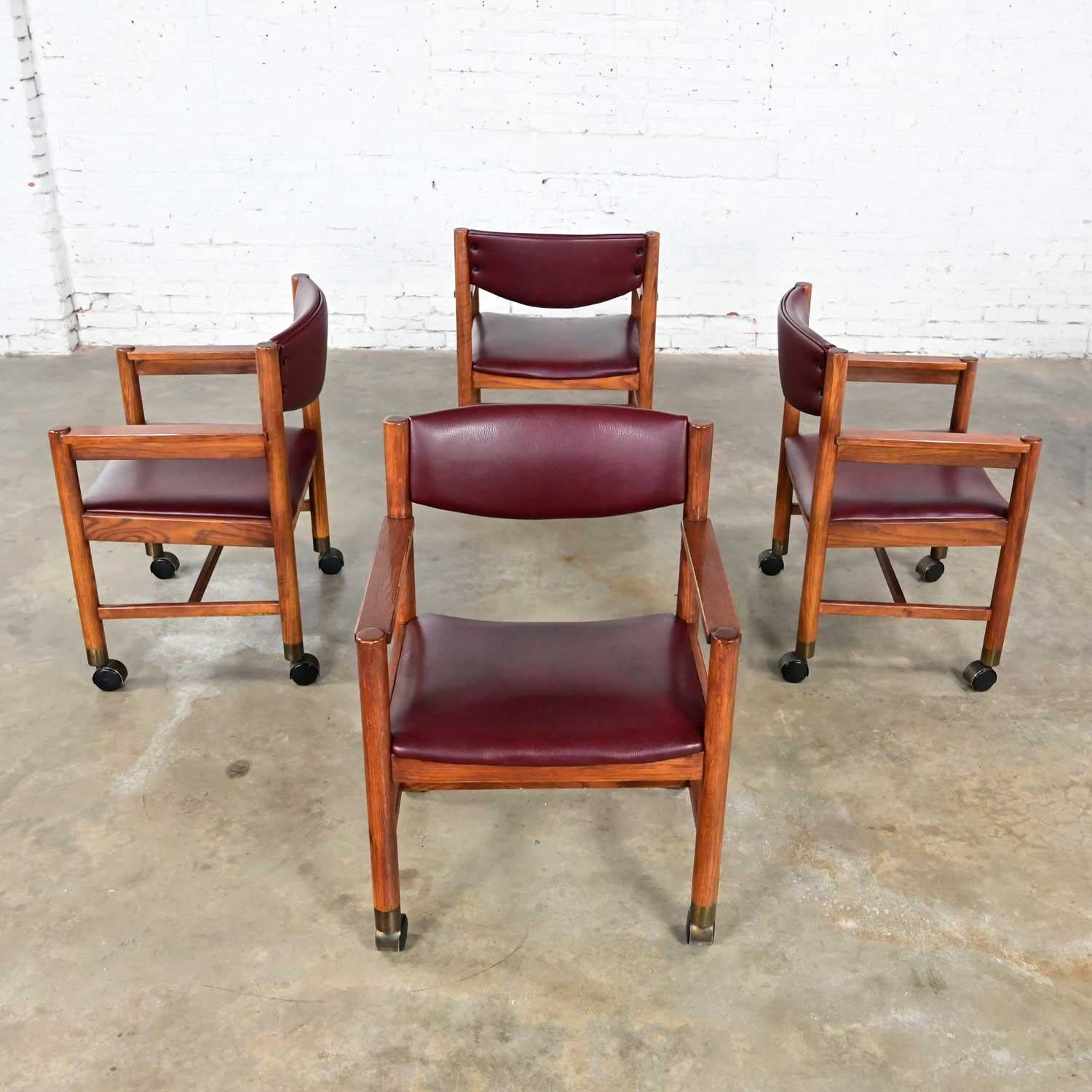 Faux Leather Mid-Century Modern to Modern Oak Maroon Vinyl Rolling Game or Dining Chairs For Sale