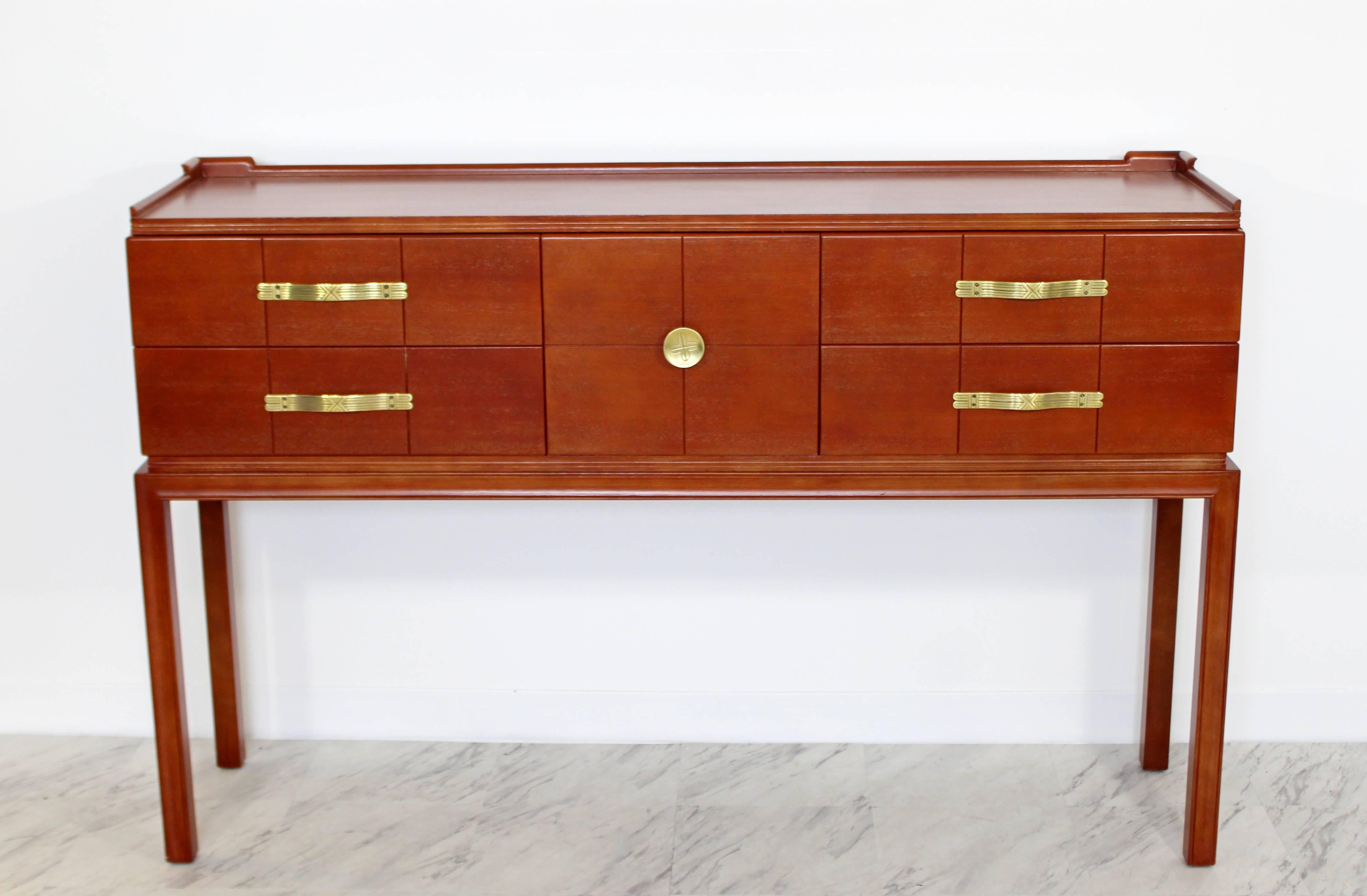 For your consideration is an absolutely stunning console table, with four drawers that have bronze pulls, by Tommi Parzinger for Charak modern, circa the 1950s. In excellent condition, just came back from being professionally refinished. The