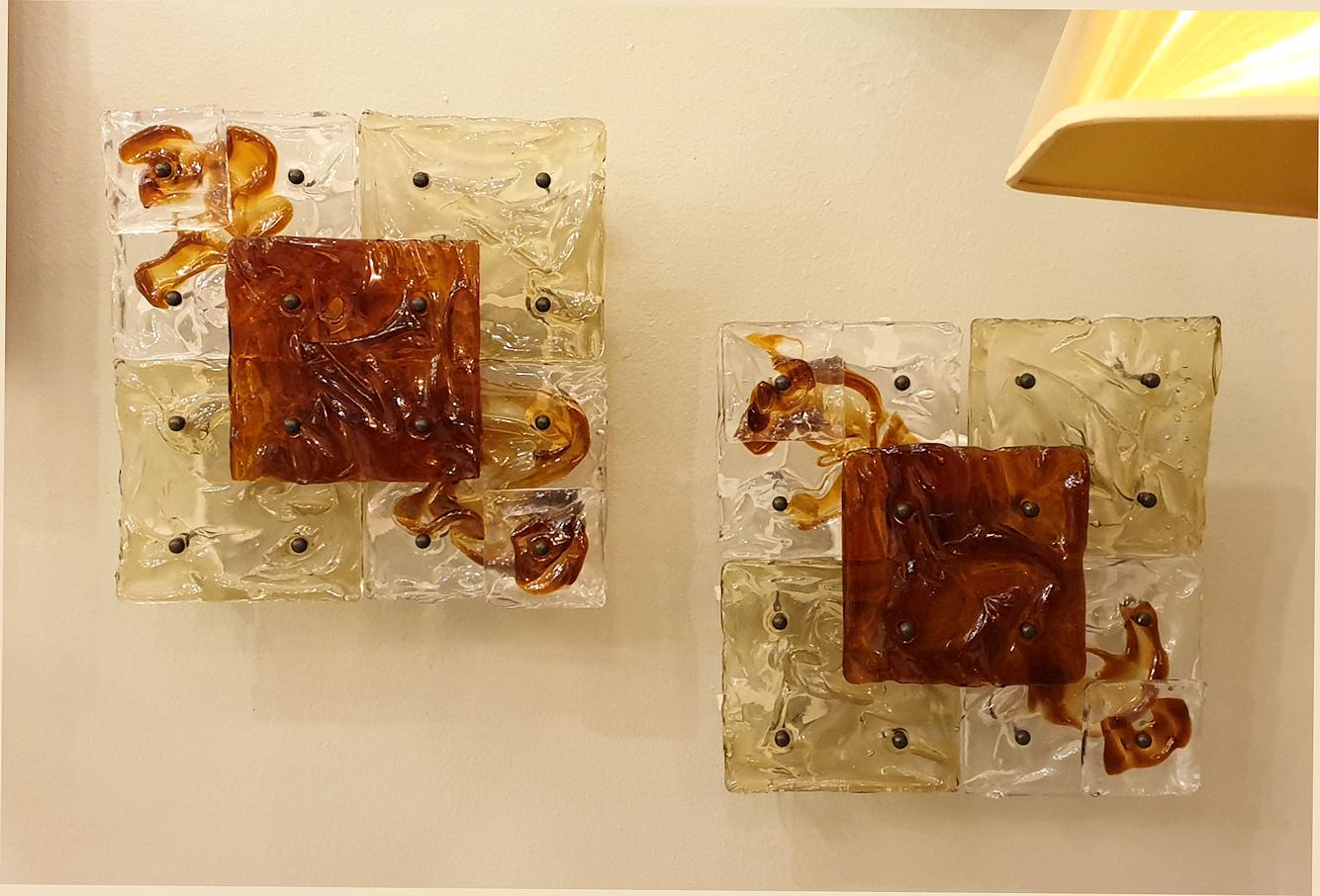 Pair of Mid-Century Modern Italian Murano clear and light brown glass square sconces or flush mount fixtures.
By Toni Zuccheri for Venini, Italy, 1970s
The vintage sconces have one candelabra light each and have been rewired for the US.
This pair