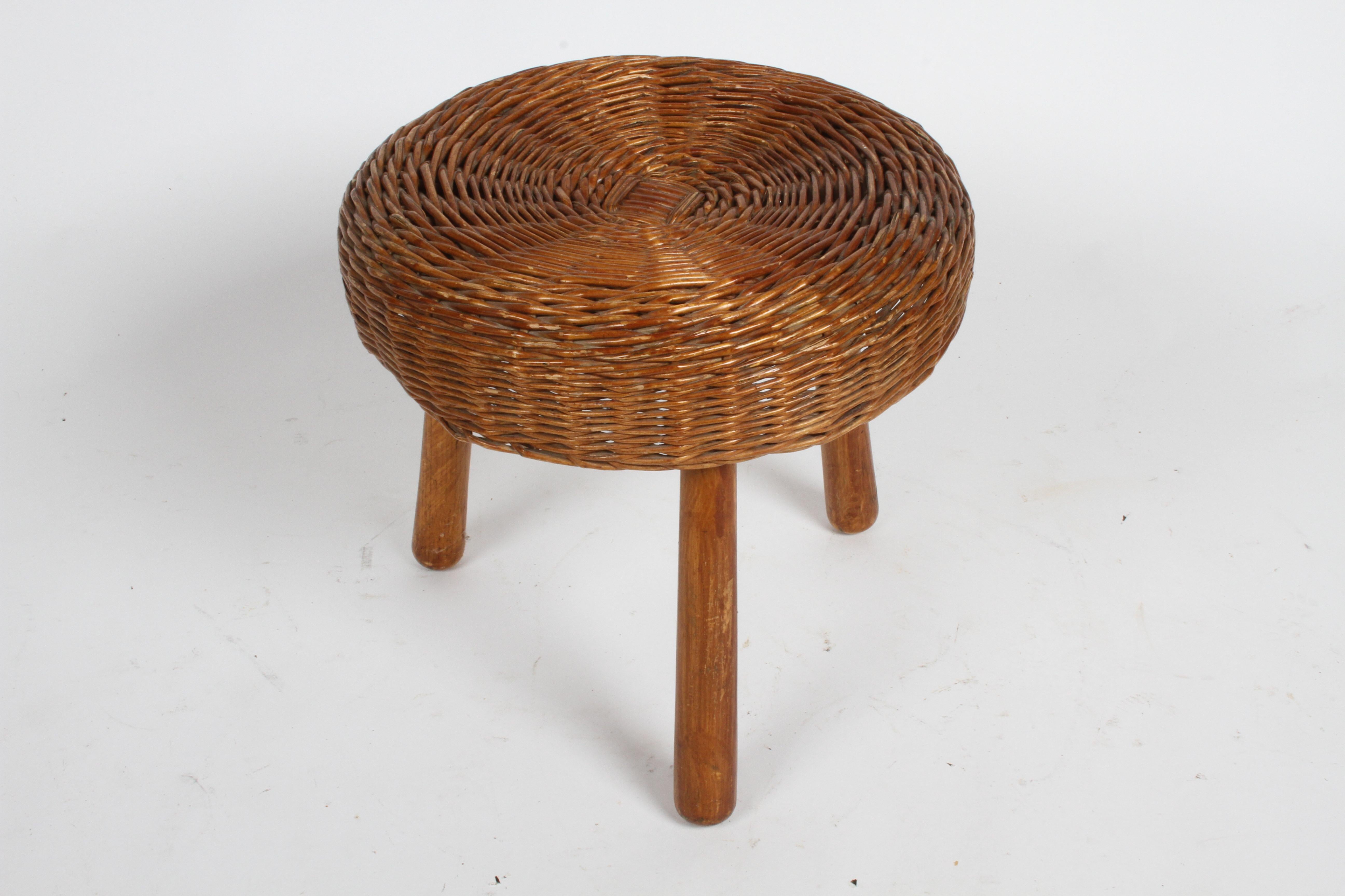 Mid-Century Modern round rattan or wicker stool on wood legs by Tony Paul. This was given out as a gift, compliments of Cliff Cornell, 