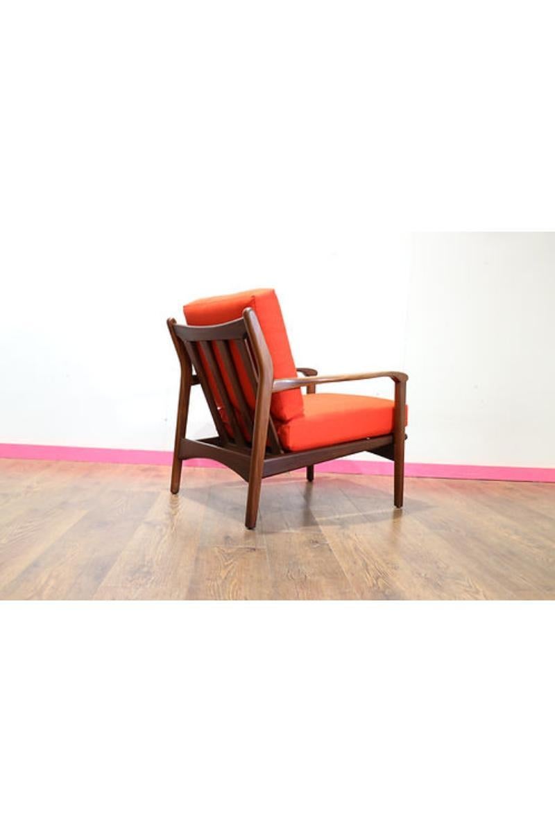 A beautiful mid century lounge chair made by British furniture maker Toothill, this piece is a must-have for any enthusiast of vintage design. Recently reupholstered in burnt orange fabric and a solid afromosia frame, this is a truly stunning chair.