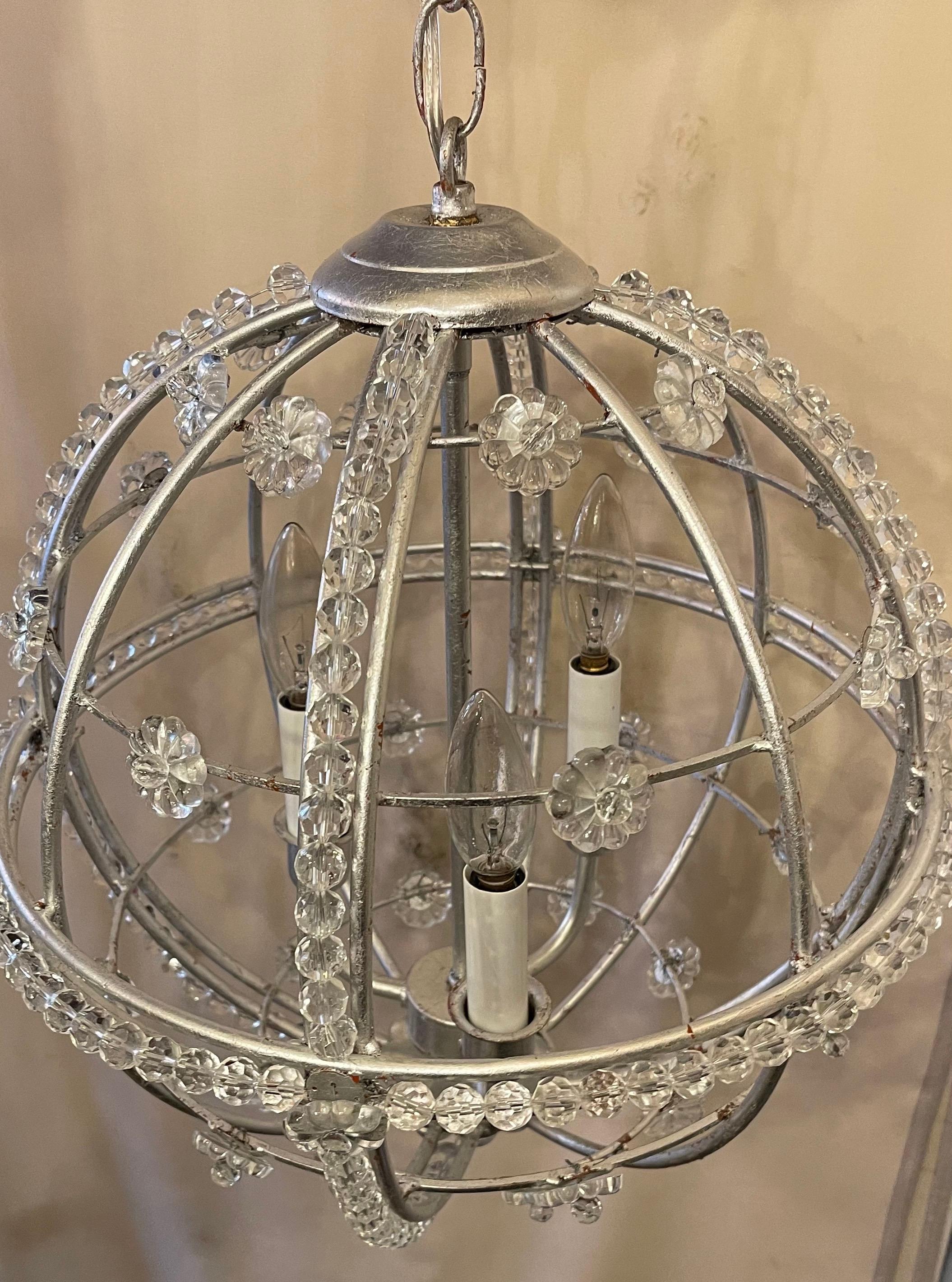 A wonderful pair of Mid-Century Modern transitional silver leaf Sputnik ball chandeliers, each fixture has 3 candelabra sockets and comes with matching chain and canopy

Each sold separately.