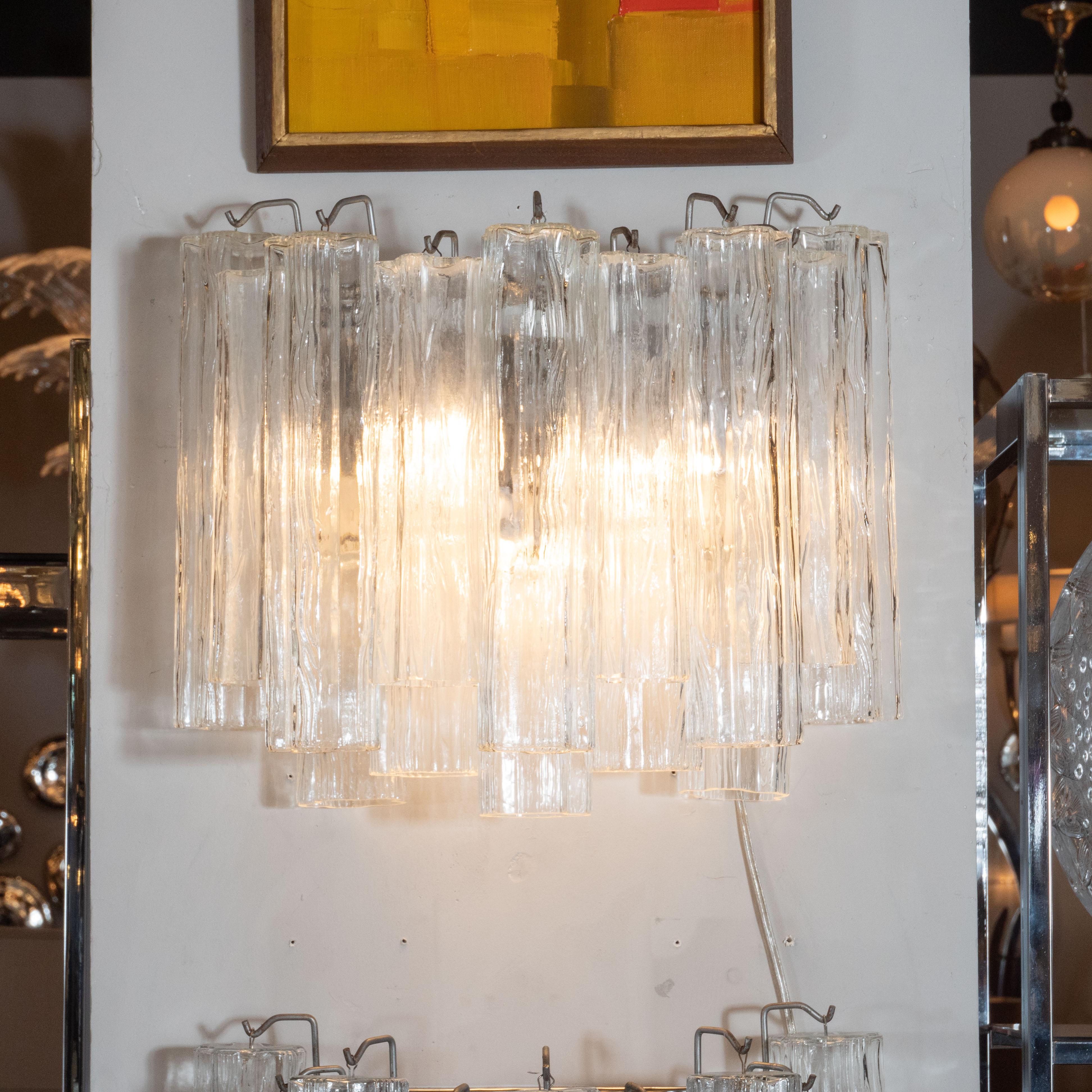 These refined tronchi sconces were handblown in Murano, Italy, circa 1970. They feature an abundance of tronchi glass crystals suspended from a nickel frame in a staggered arrangement. The light refracts beautifully through the glass casting any