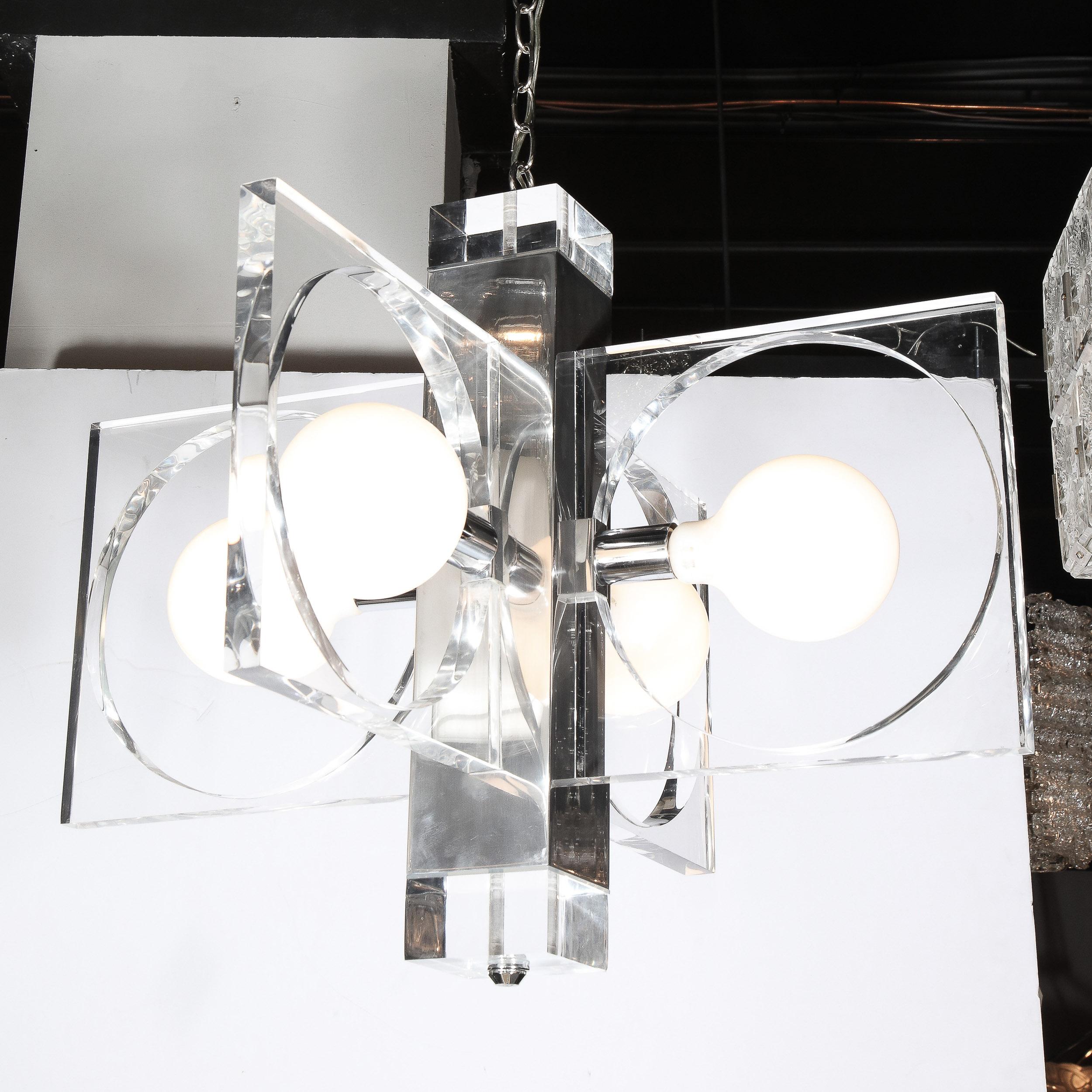 This sophisticated Mid-Century Modern chandelier was realized in Italy, circa 1970. It features a rectangular body in lustrous polished chrome capped on each end by solid volumetric square blocks of translucent lucite. The bottom block is capped at